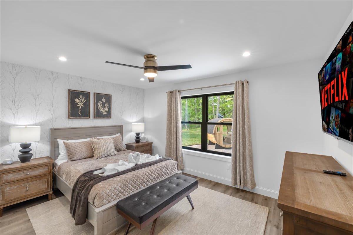 Wake up refreshed in this nature-inspired bedroom with cozy bedding and botanical artwork.