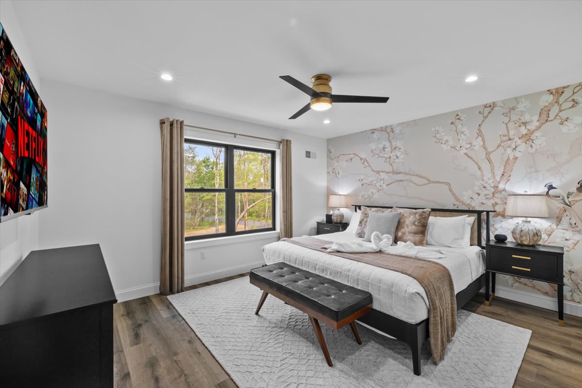 Cherry blossom wallpaper and a canopy bed make the fourth bedroom a stunning retreat.