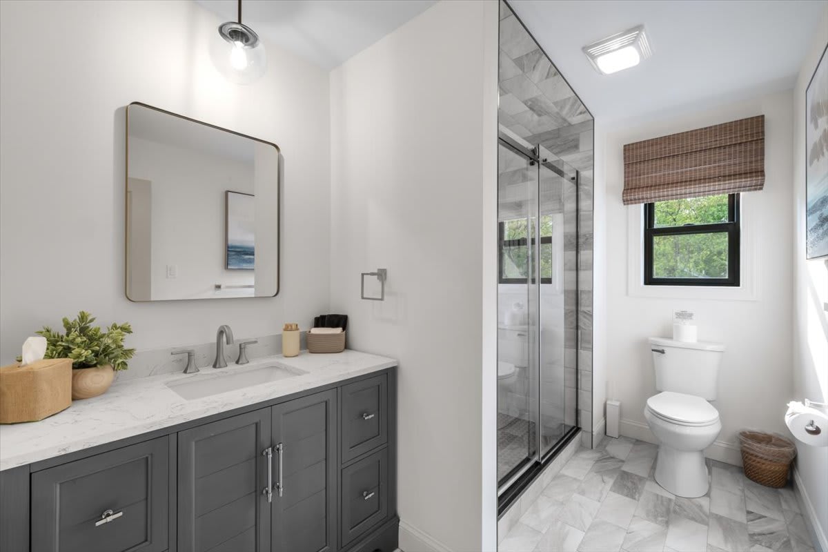 Unwind in the spacious bathroom with modern tile flooring and ample natural light.