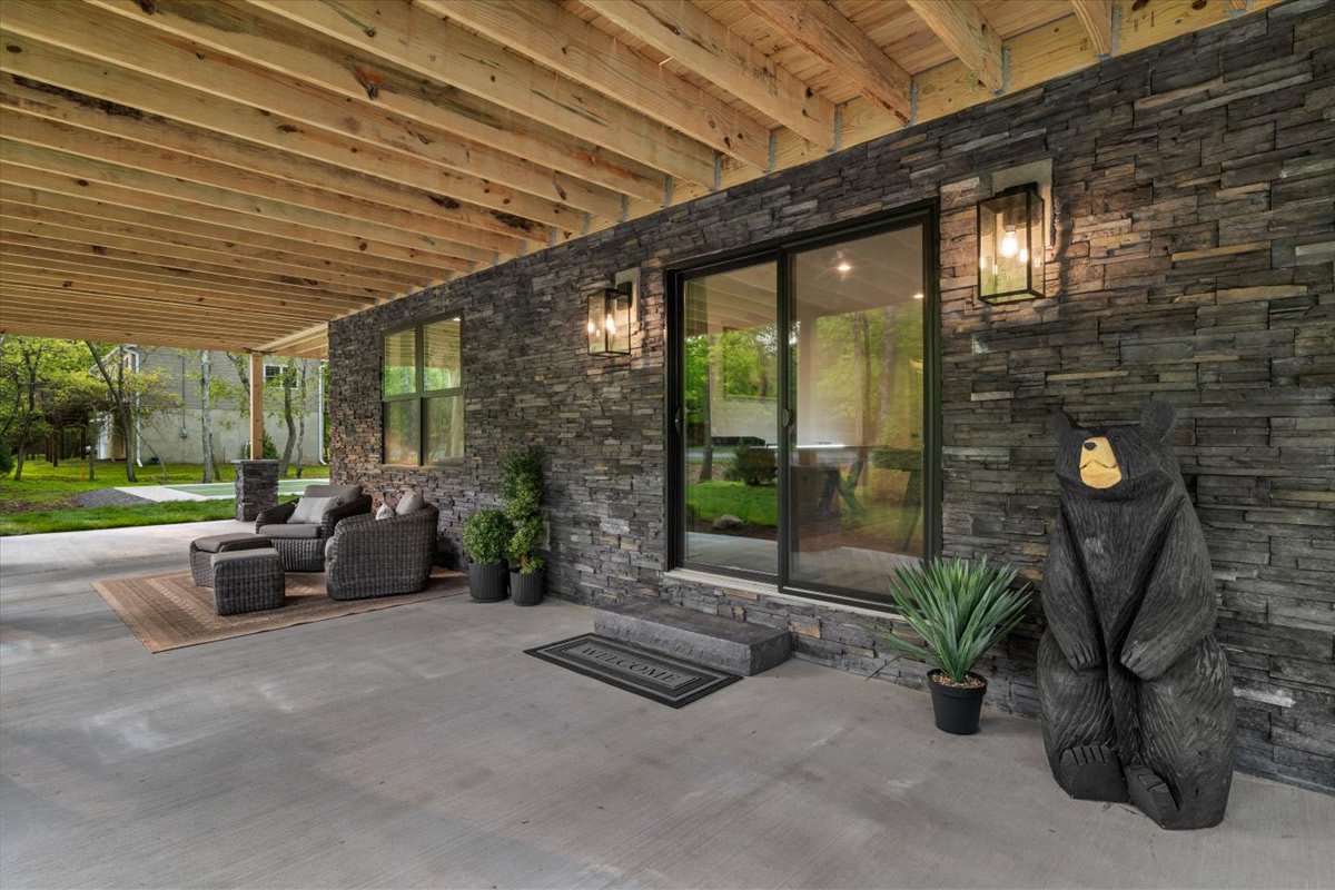 A friendly bear greets you at the stone-accented entry patio.