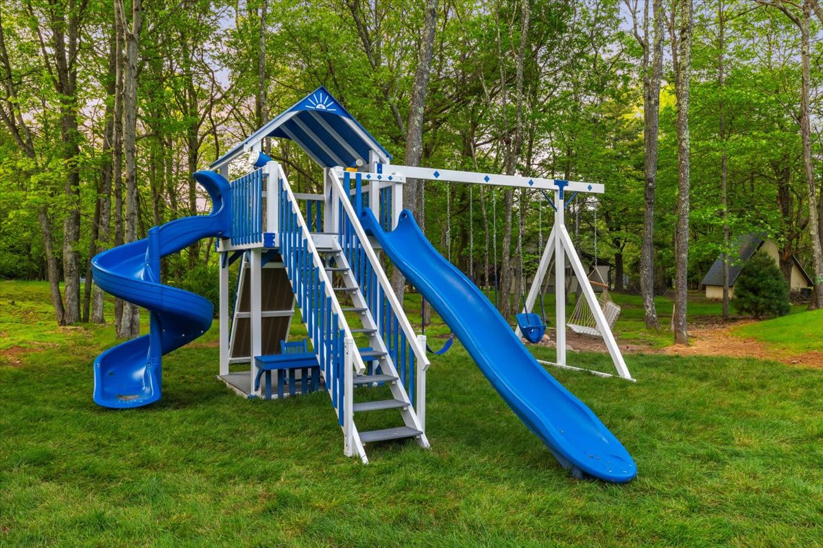 Kids can climb, slide, and swing on the backyard playground.