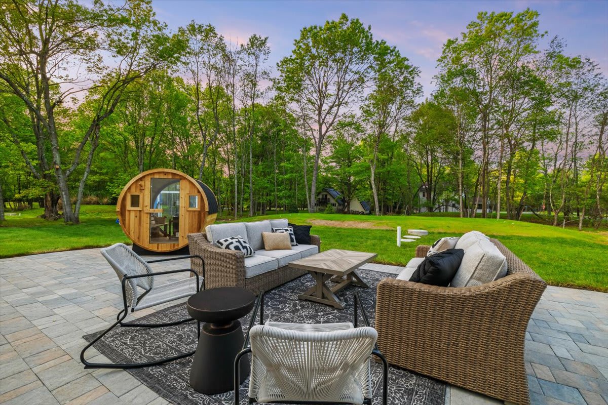 Gather around in the outdoor lounge area with comfortable wicker seating.