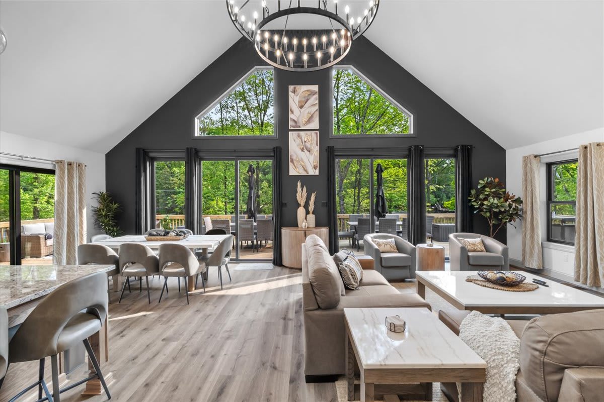 Vaulted ceilings and a statement chandelier define the open living and dining area.