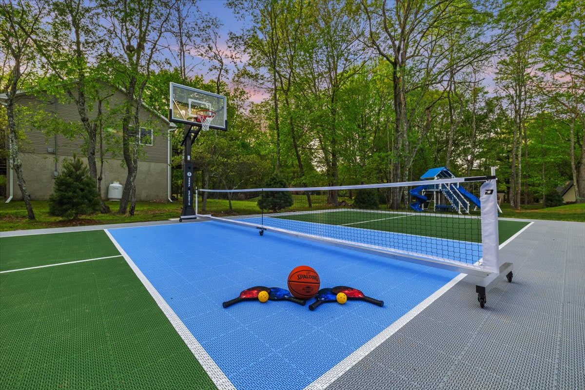 Challenge everyone to basketball or pickleball on the backyard sports court.