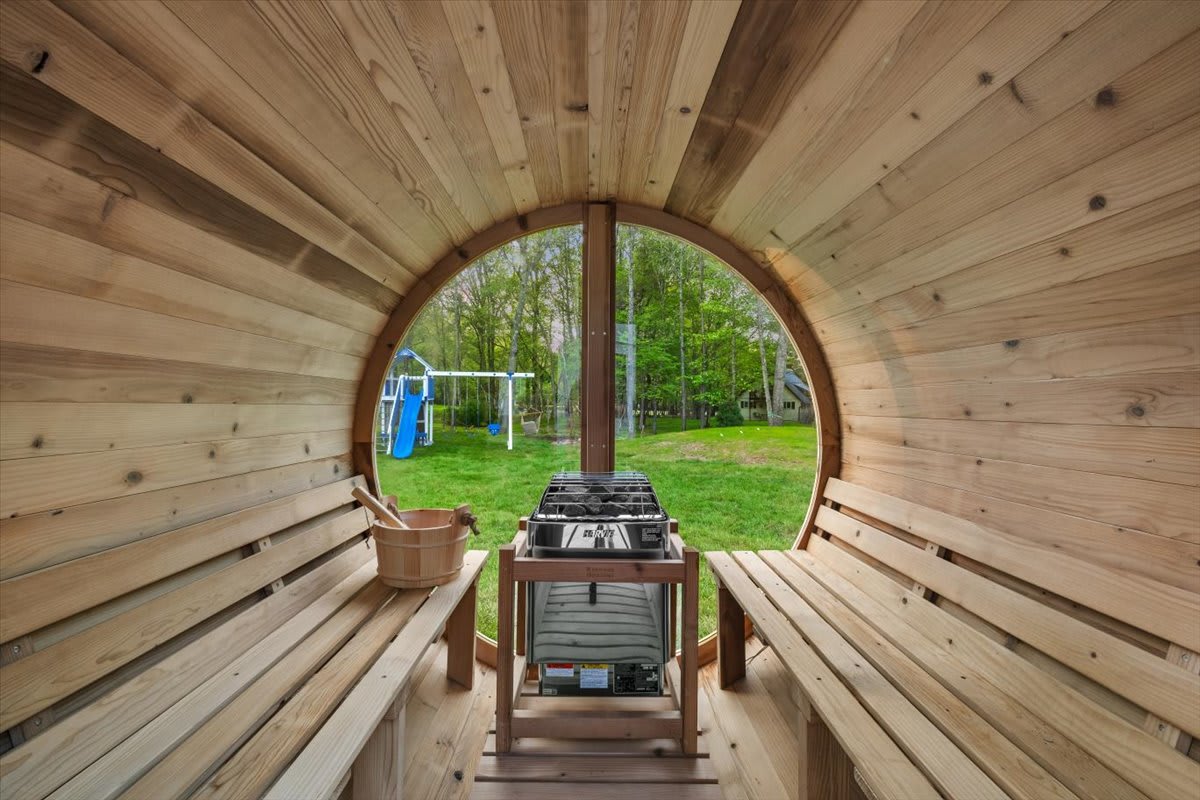 Warm up in the cedar barrel sauna with views of the backyard.