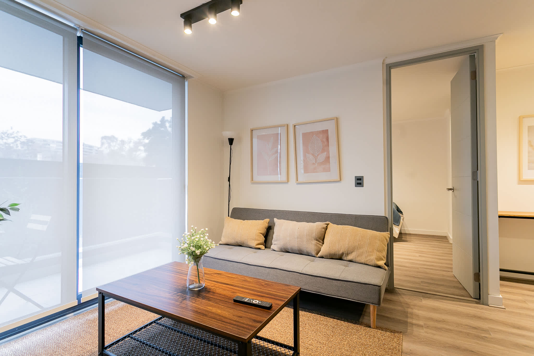 Relax in this cozy living room with natural light and stylish decor, perfect for unwinding after a day of exploring.