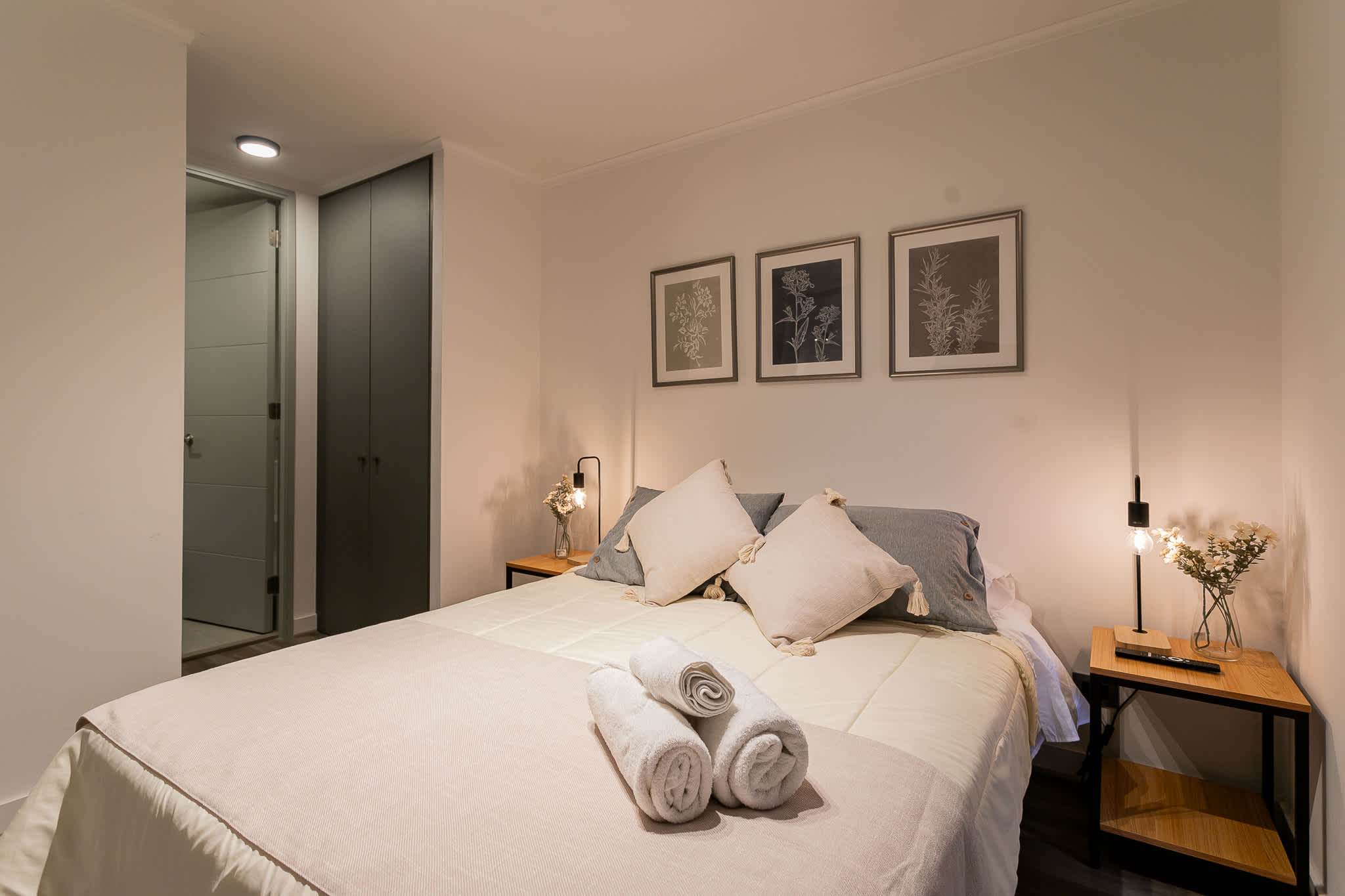 Relax in this serene bedroom with cozy bedding and stylish decor, perfect for unwinding after a day of exploring.