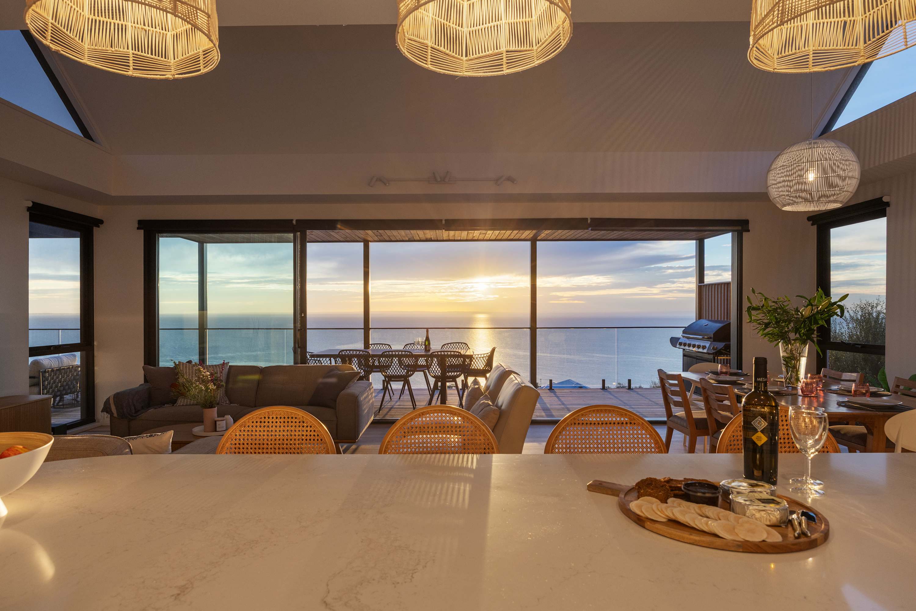 Kitchen bench overlooking living room and outdoor seating.