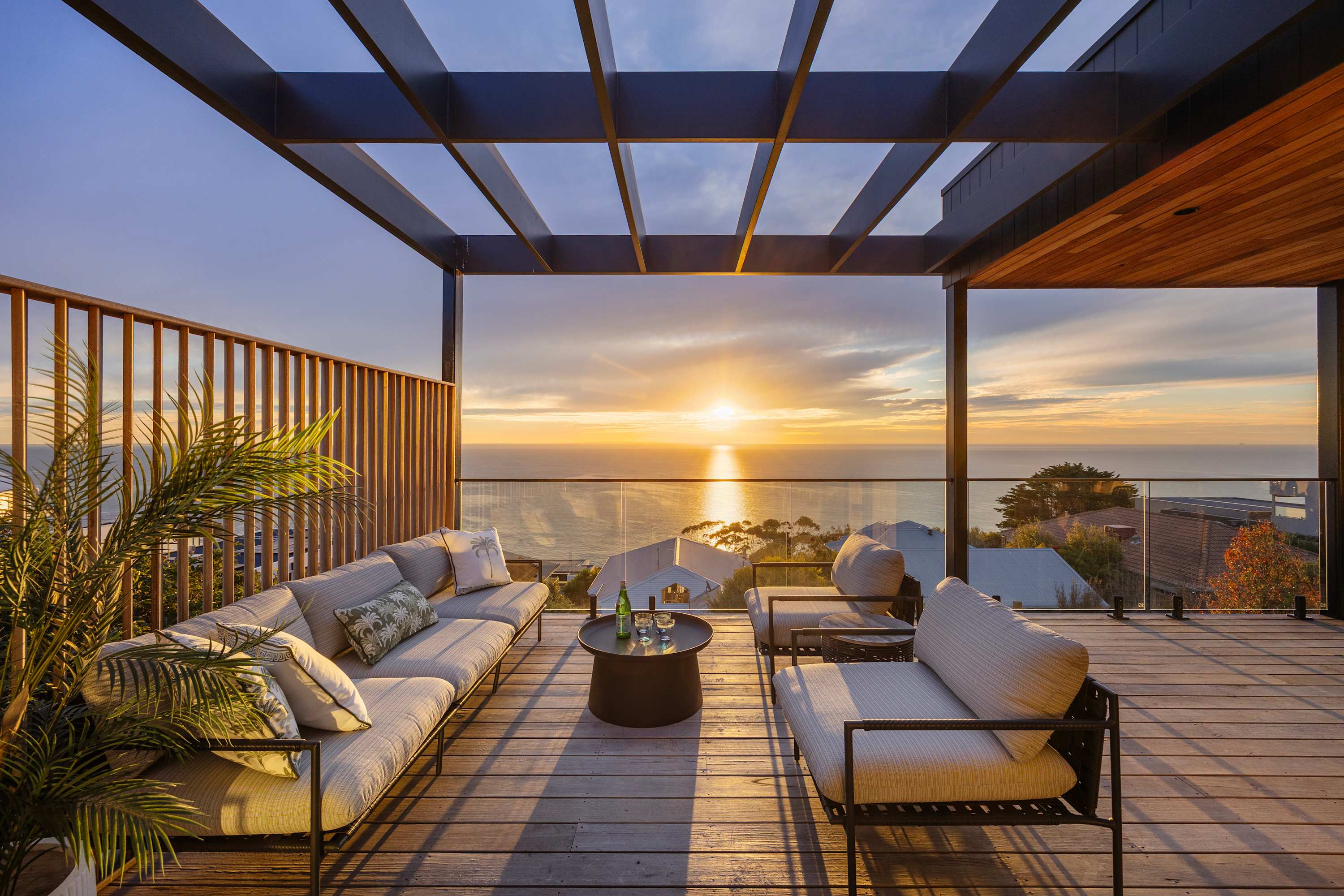 Left side outdoor seating overlooking the ocean at dusk.