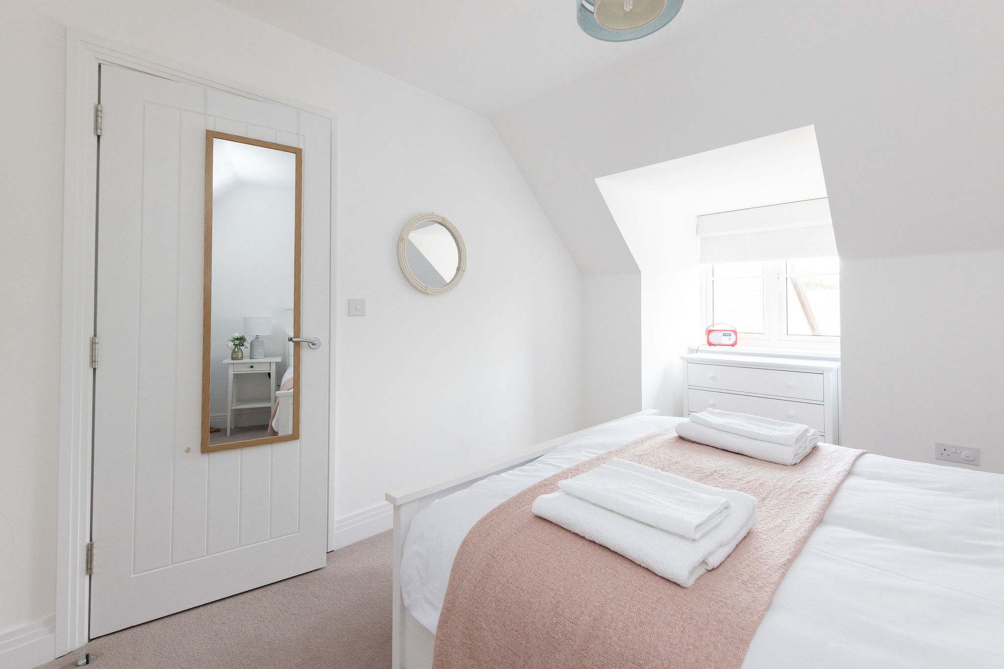 A bright and peaceful bedroom for your own quiet sanctuary.