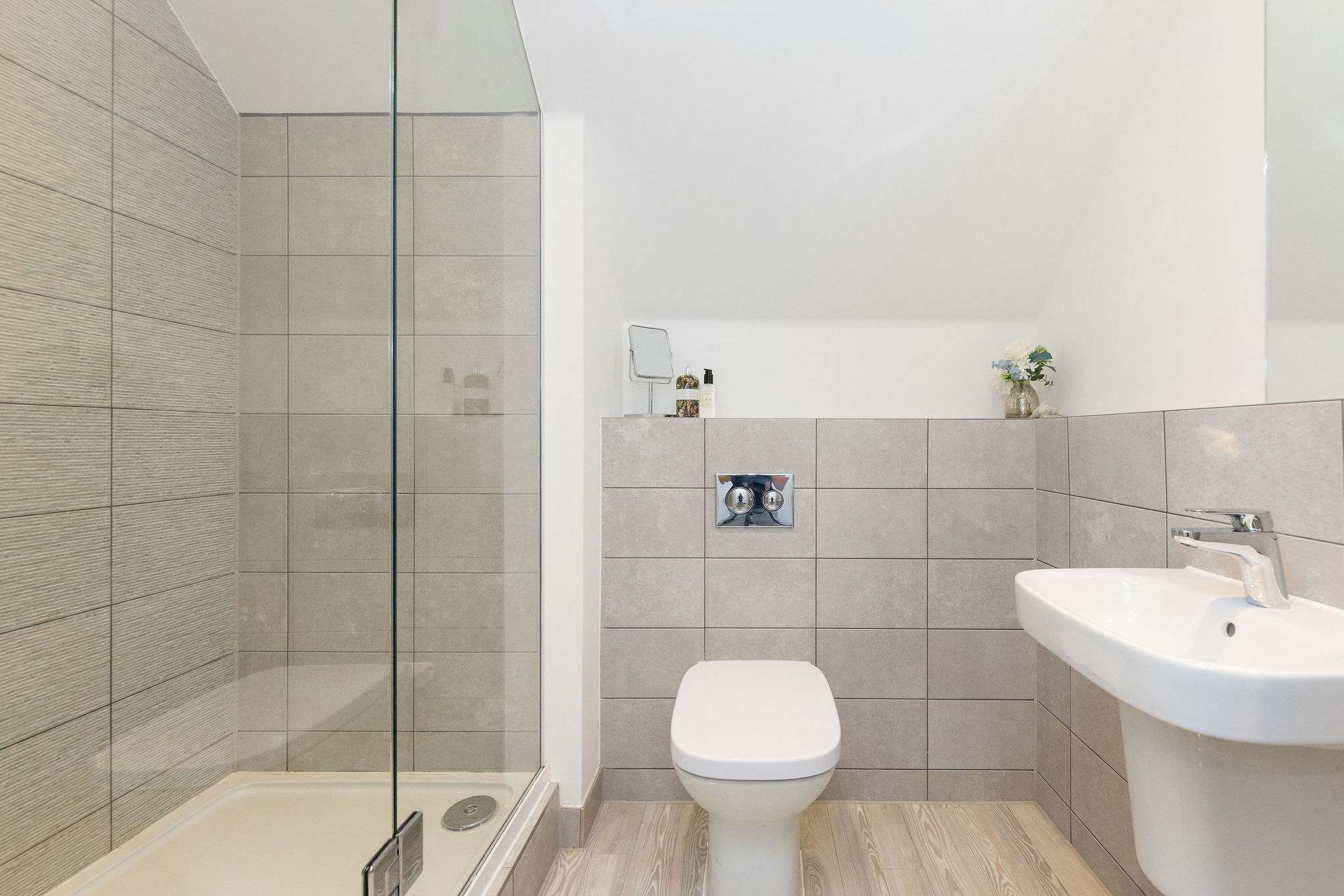 A modern bathroom featuring a spacious walk-in shower, perfect for freshening up.
