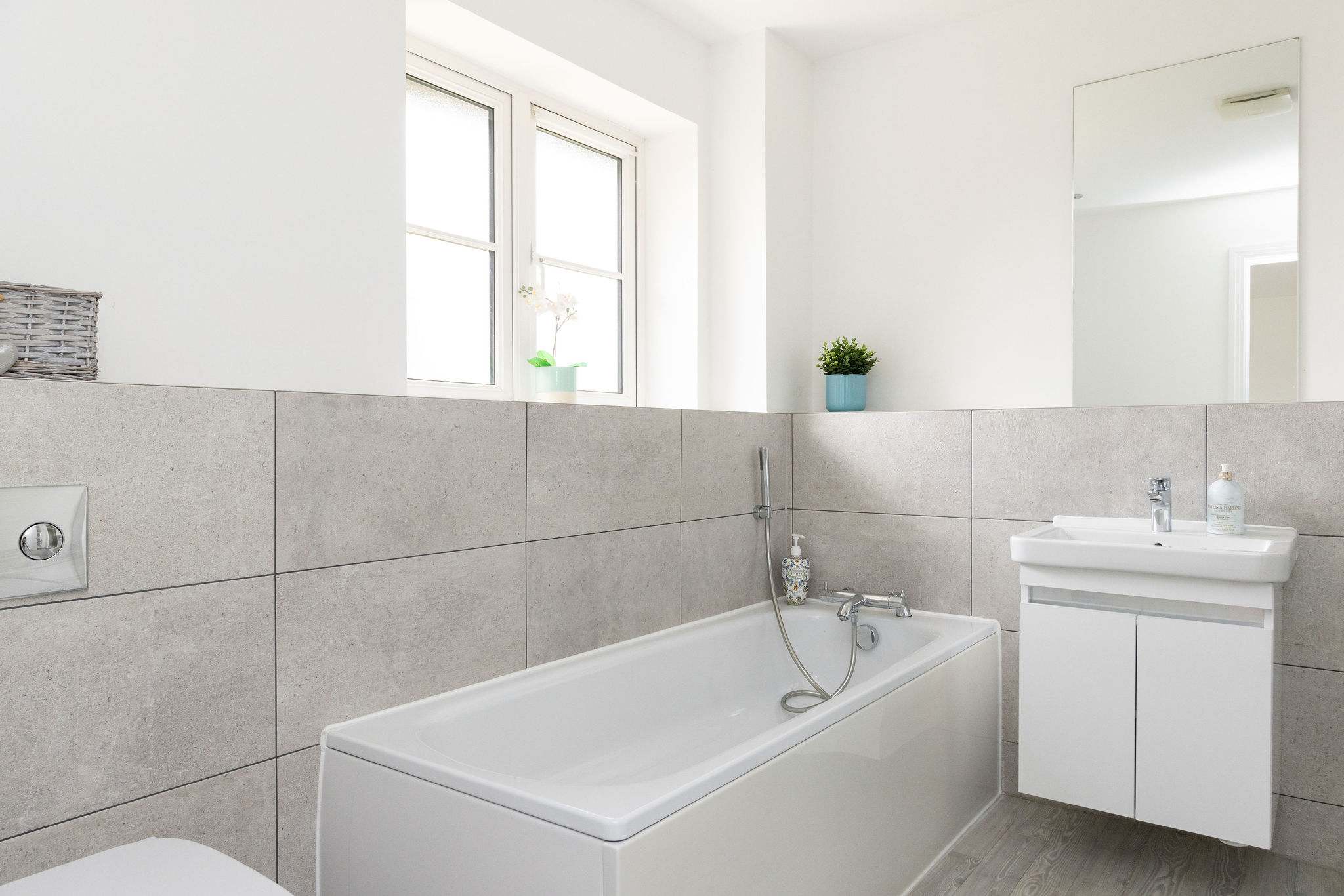 The modern and bright en-suite, complete with a full-size bathtub for a relaxing soak after a day of exploring.