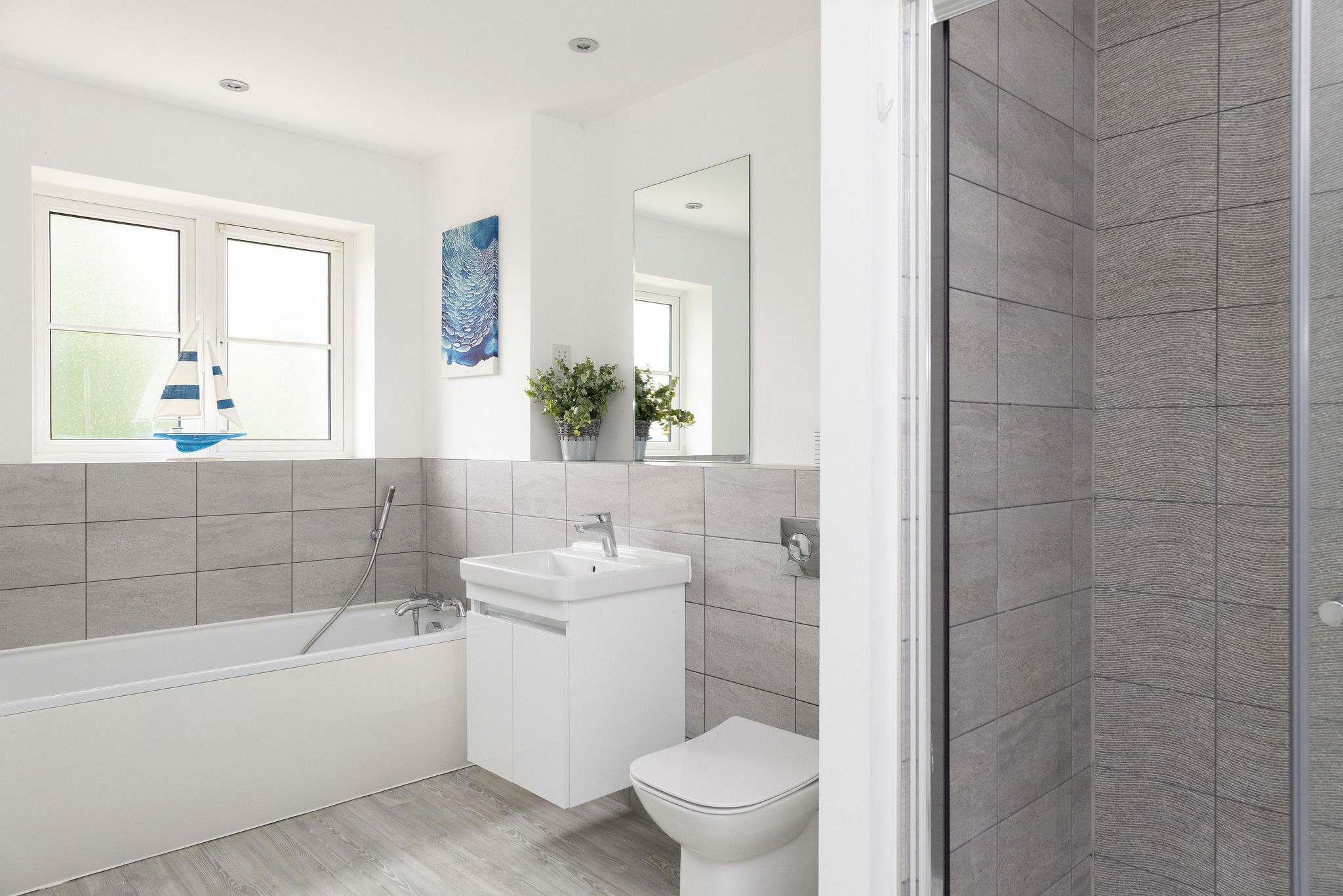 The modern bathroom, conveniently equipped with both a full-size bath and a separate walk-in shower.