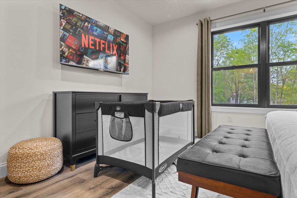 The fourth bedroom includes a crib for little ones and a TV for winding down.