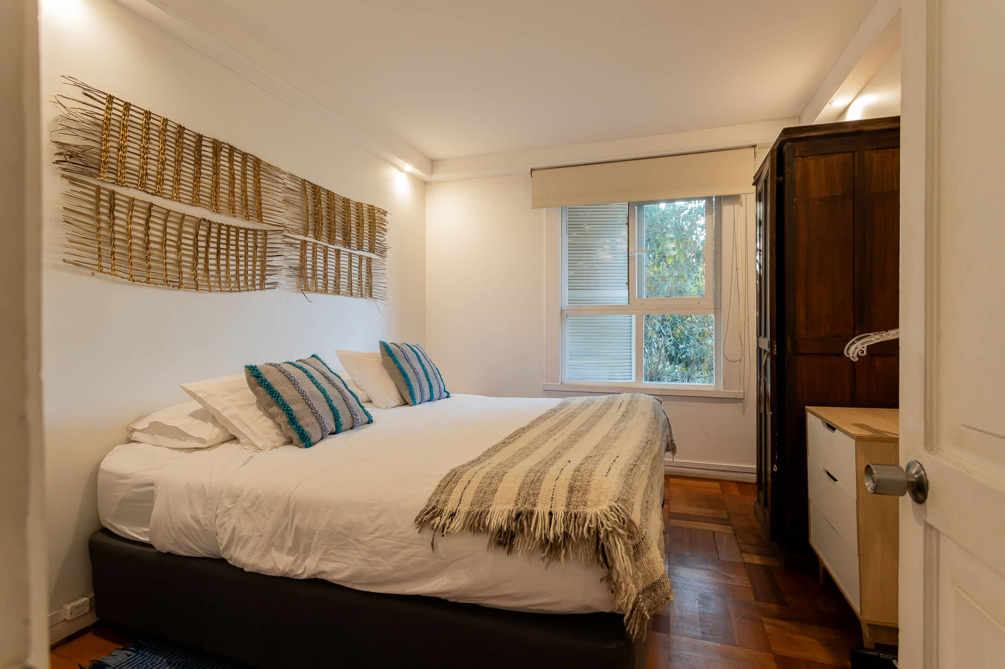 Relax in this cozy bedroom with a plush bed, stylish decor, and a serene view. Perfect for unwinding after a day of exploring.