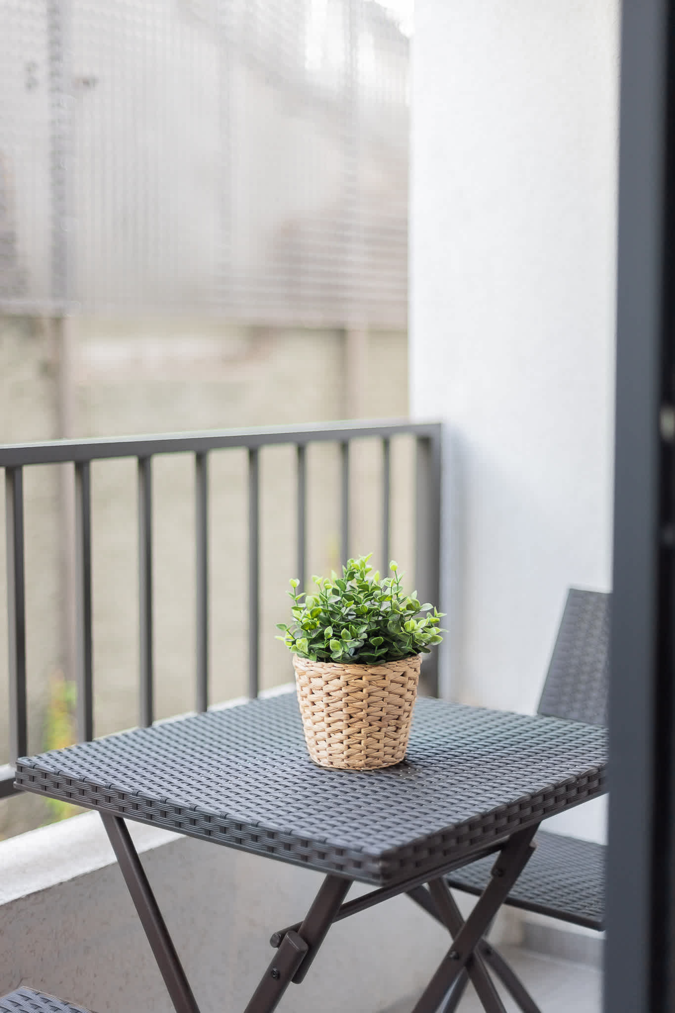 Enjoy a peaceful morning coffee on your private balcony with a charming view and cozy seating.