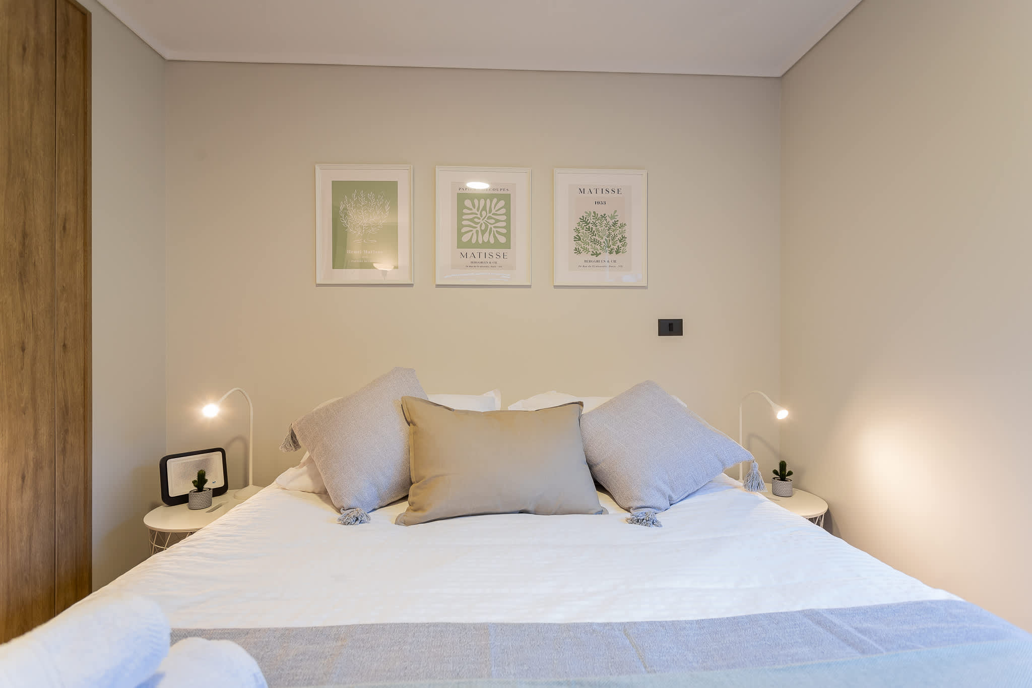 Relax in this cozy, artfully decorated bedroom featuring soft lighting and stylish decor for a restful stay.