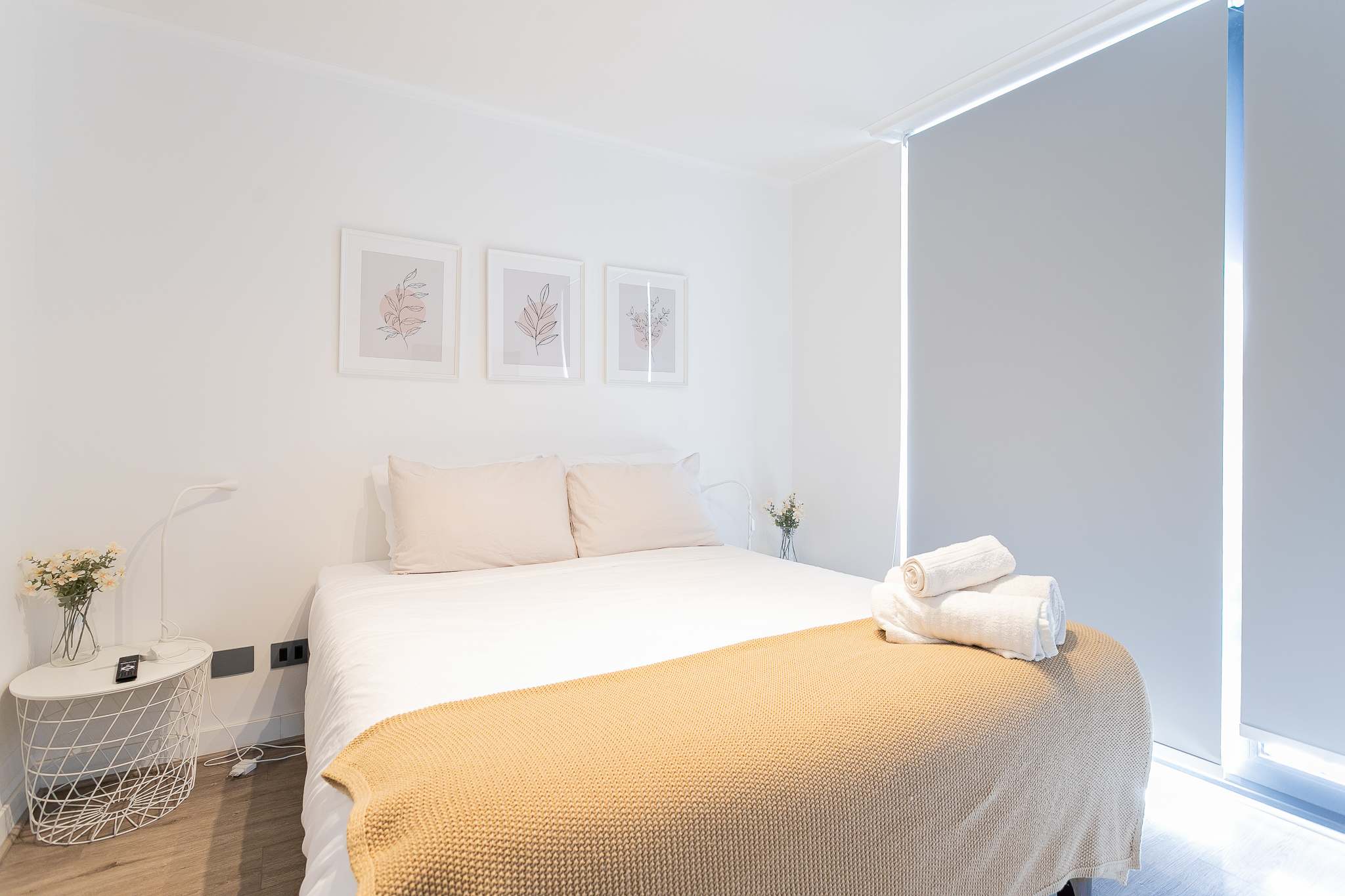 Relax in this bright and cozy bedroom featuring a plush bed and soothing decor, perfect for a restful stay.