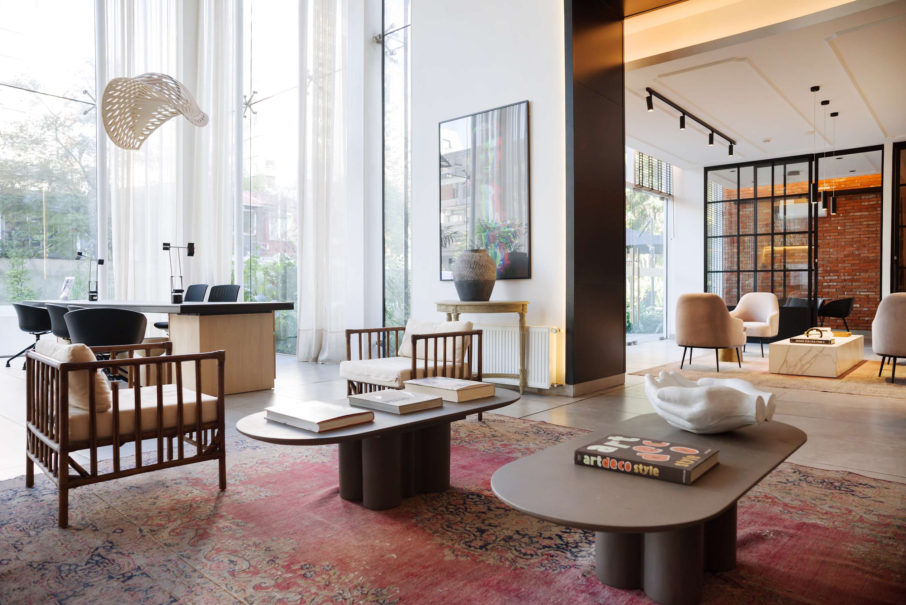 Relax in this elegant lounge with modern decor and abundant natural light, perfect for unwinding or socializing.