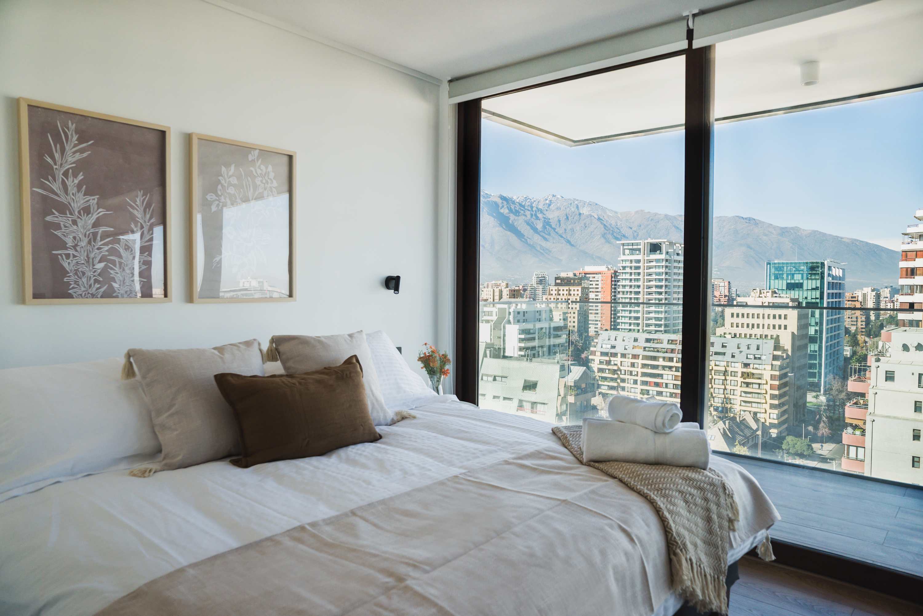 Enjoy breathtaking city and mountain views from this serene and stylish bedroom retreat.