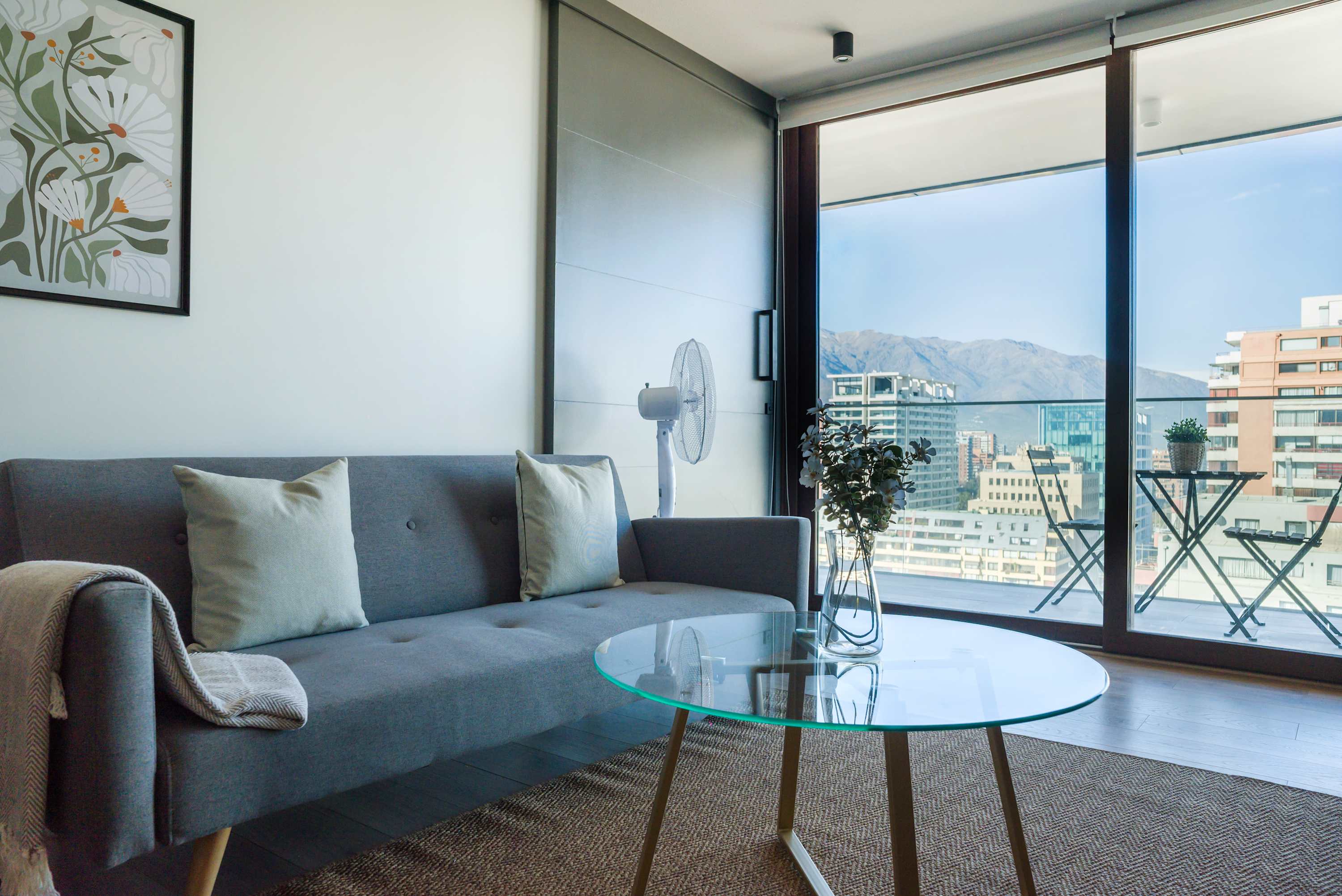 Relax in this chic living room with breathtaking city and mountain views, perfect for unwinding.