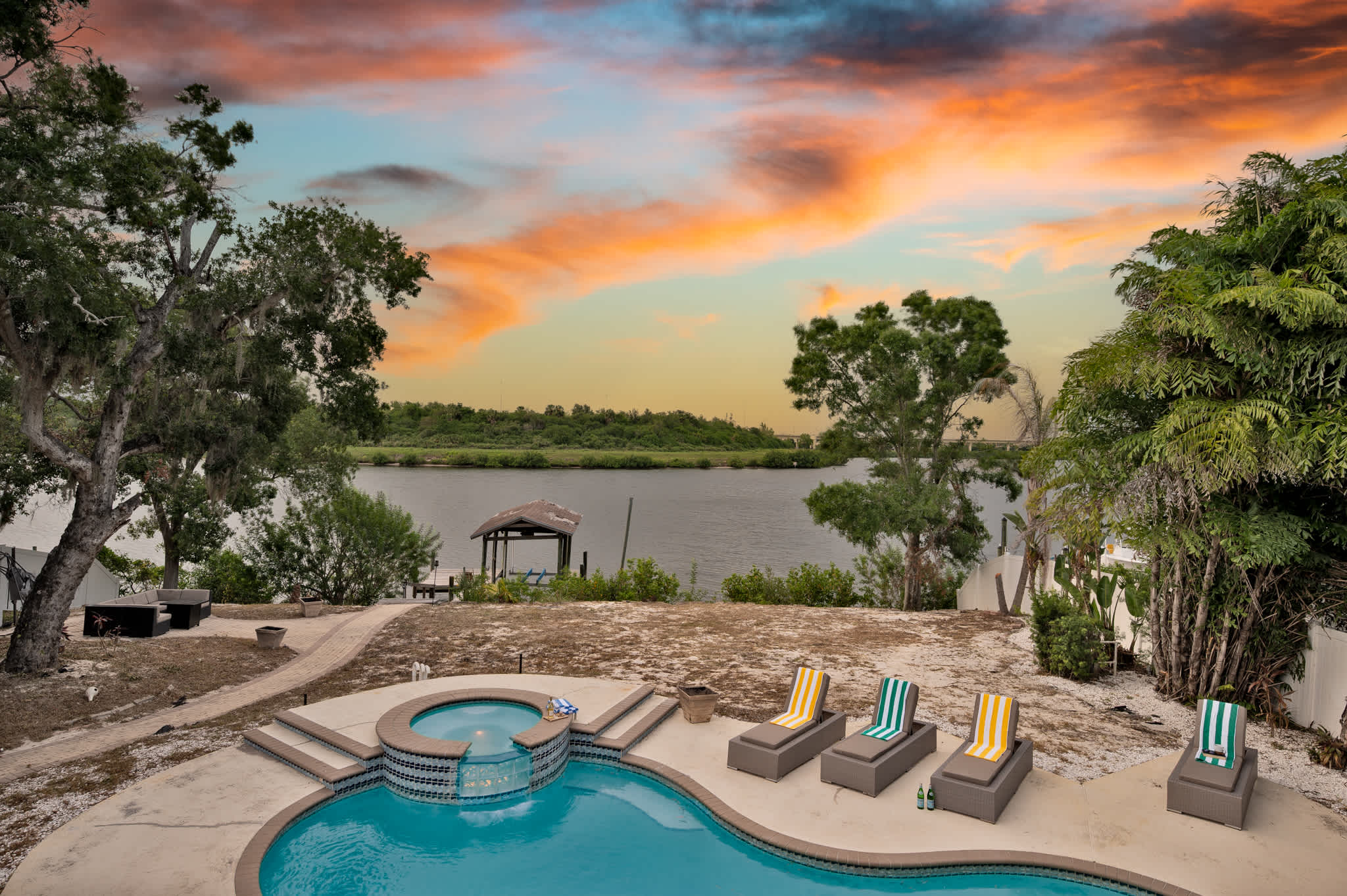 Evening enchantment awaits! Enjoy a relaxing soak in the spa or a refreshing swim under the twinkling string lights. *Dock in the back is completely off limits*