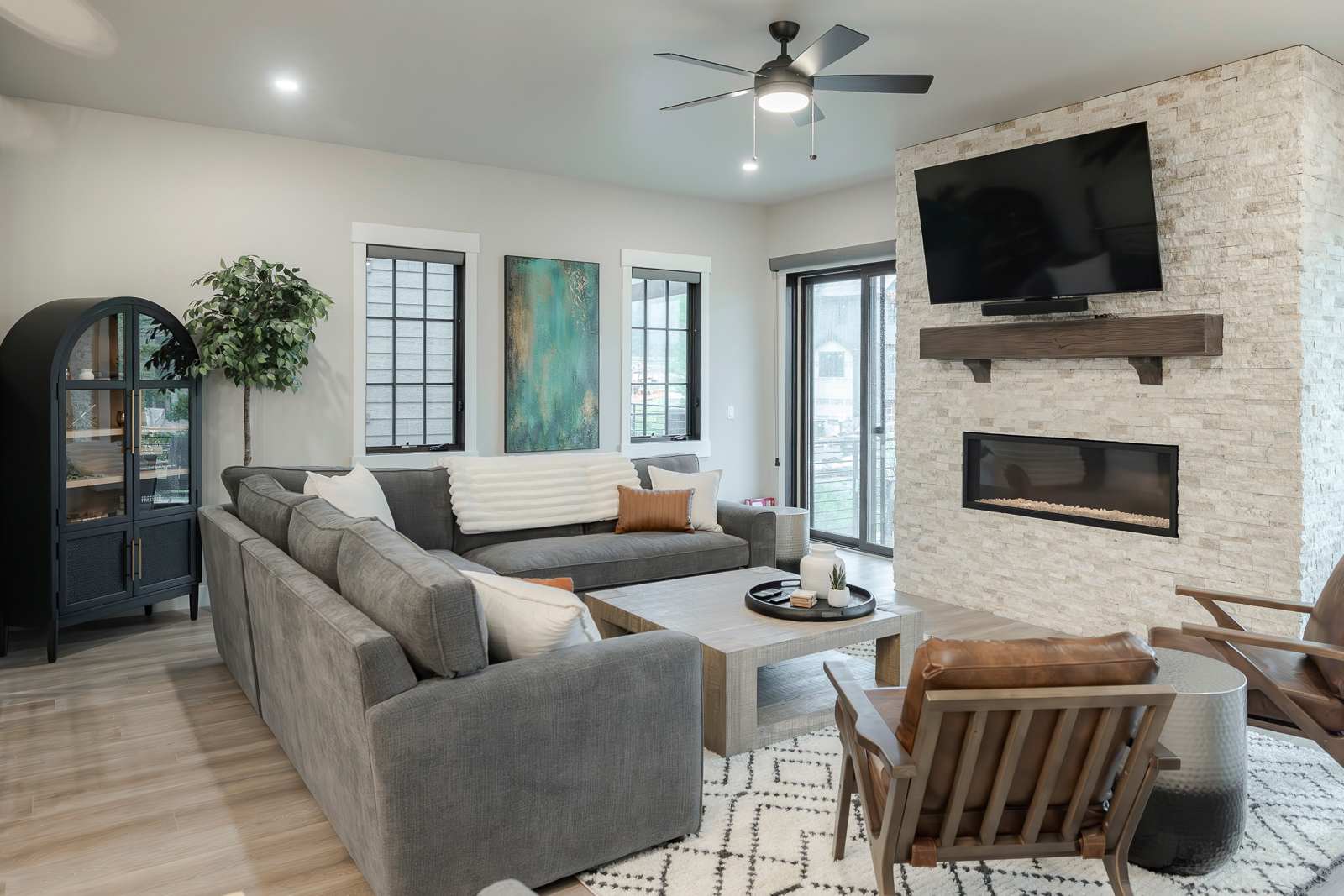 - Settle into this stylish living room, where a cozy fireplace and comfortable seating create the perfect space for unwinding. It's the ideal spot to relax and reconnect with loved ones after a day of adventure.