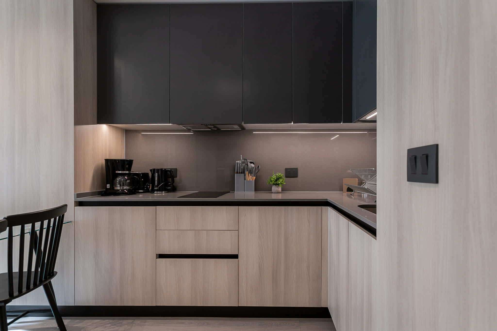 Sleek and modern kitchen with all essentials for a comfortable stay, perfect for cooking and enjoying meals.