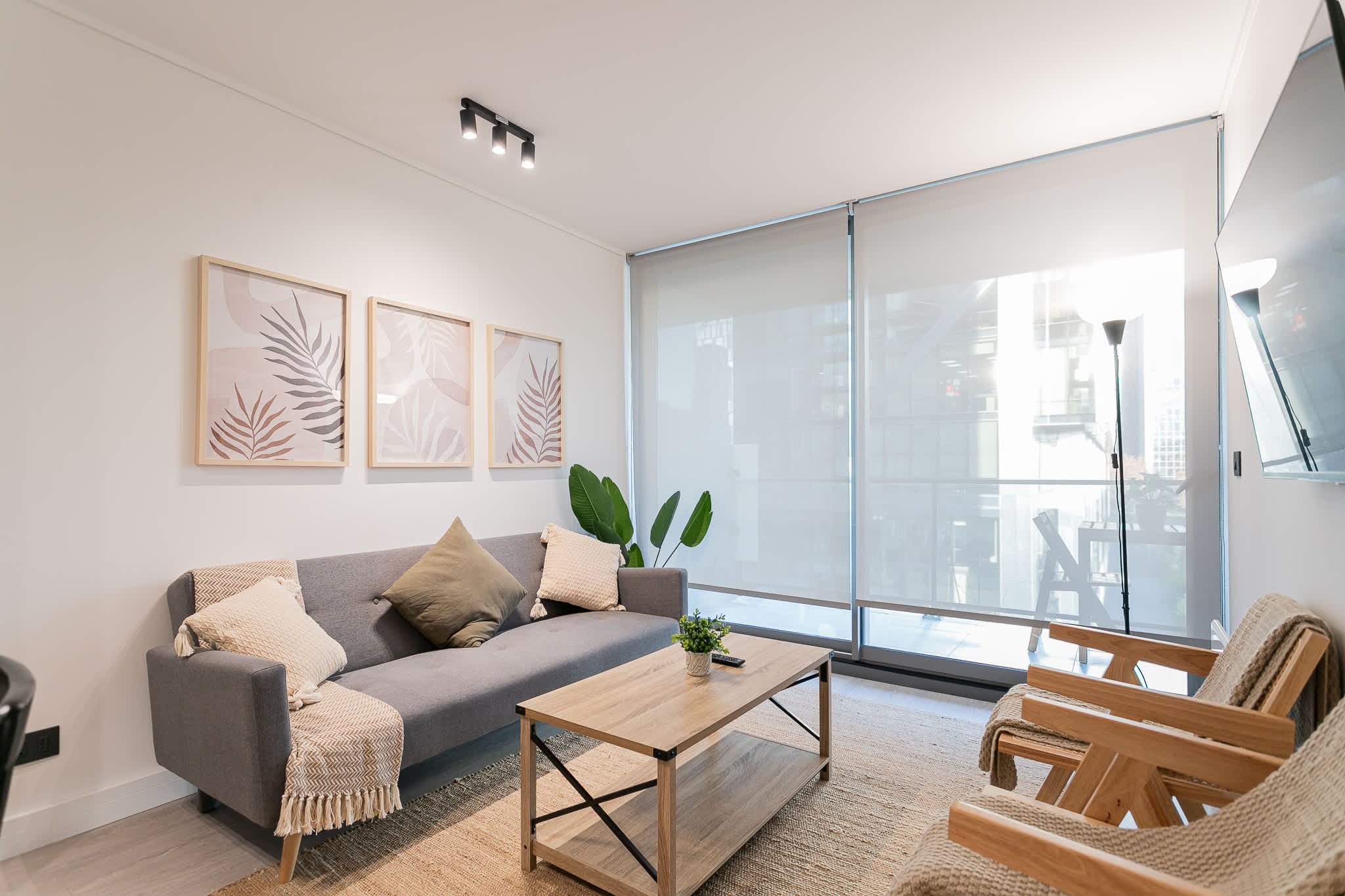 Bright and modern living room with cozy seating and natural light, perfect for relaxation and unwinding.