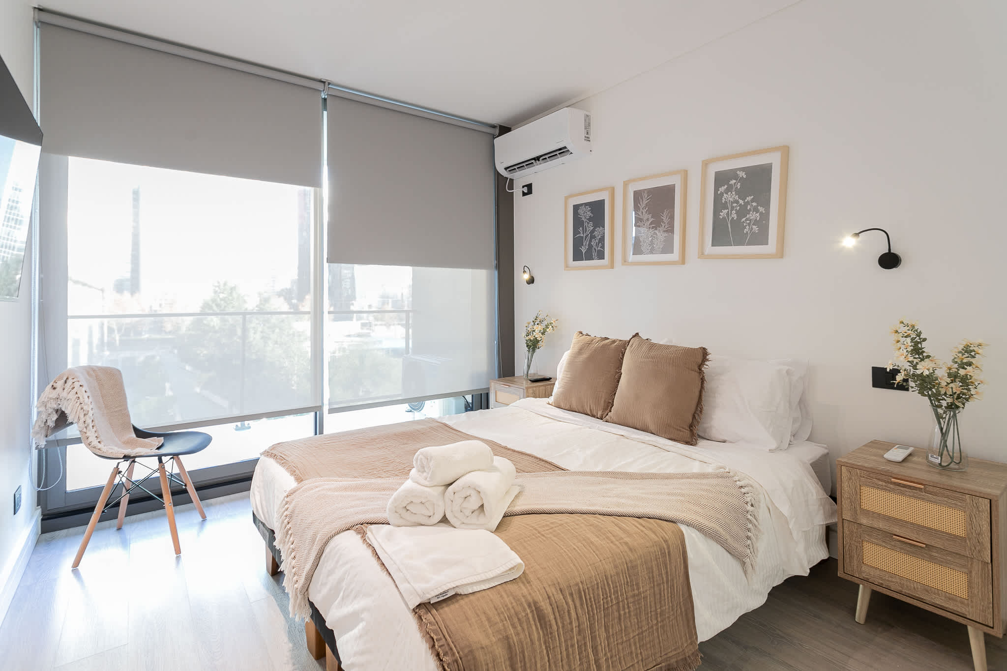 Relax in this serene bedroom with cozy bedding, stylish decor, and abundant natural light.