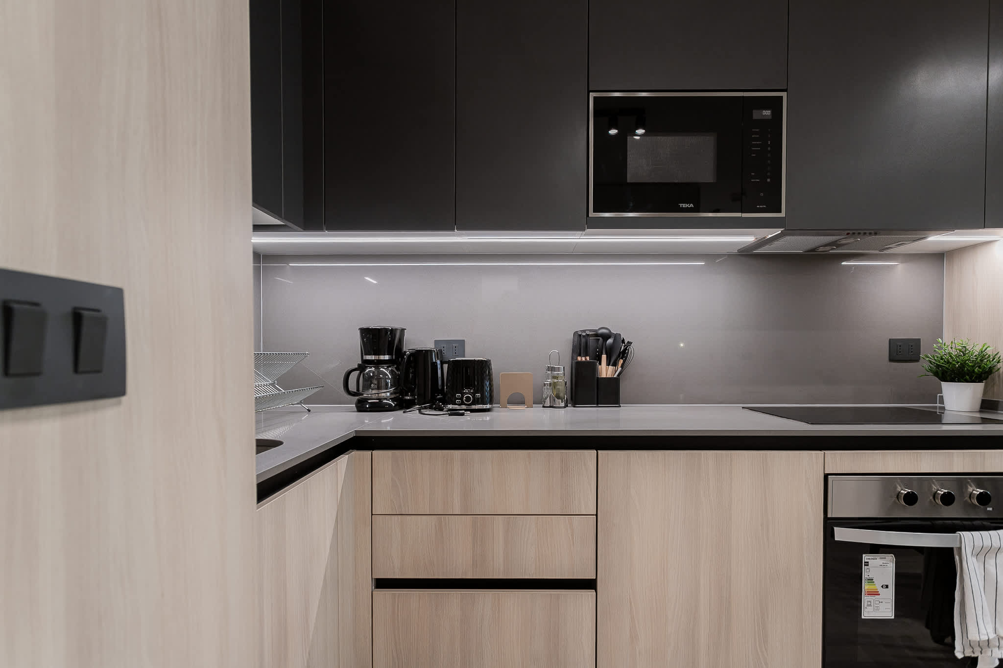 Sleek and modern kitchen equipped with all essentials for a cozy culinary experience.