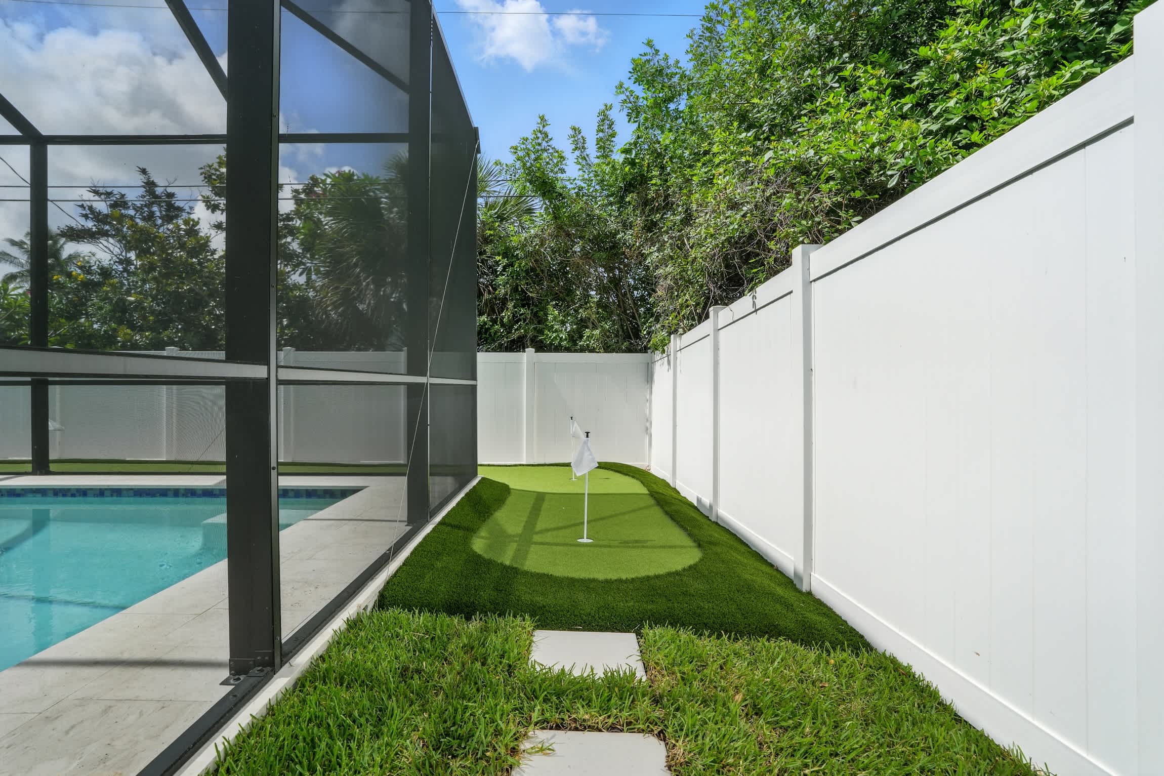 The mini golf course wraps around the back of the pool screen 