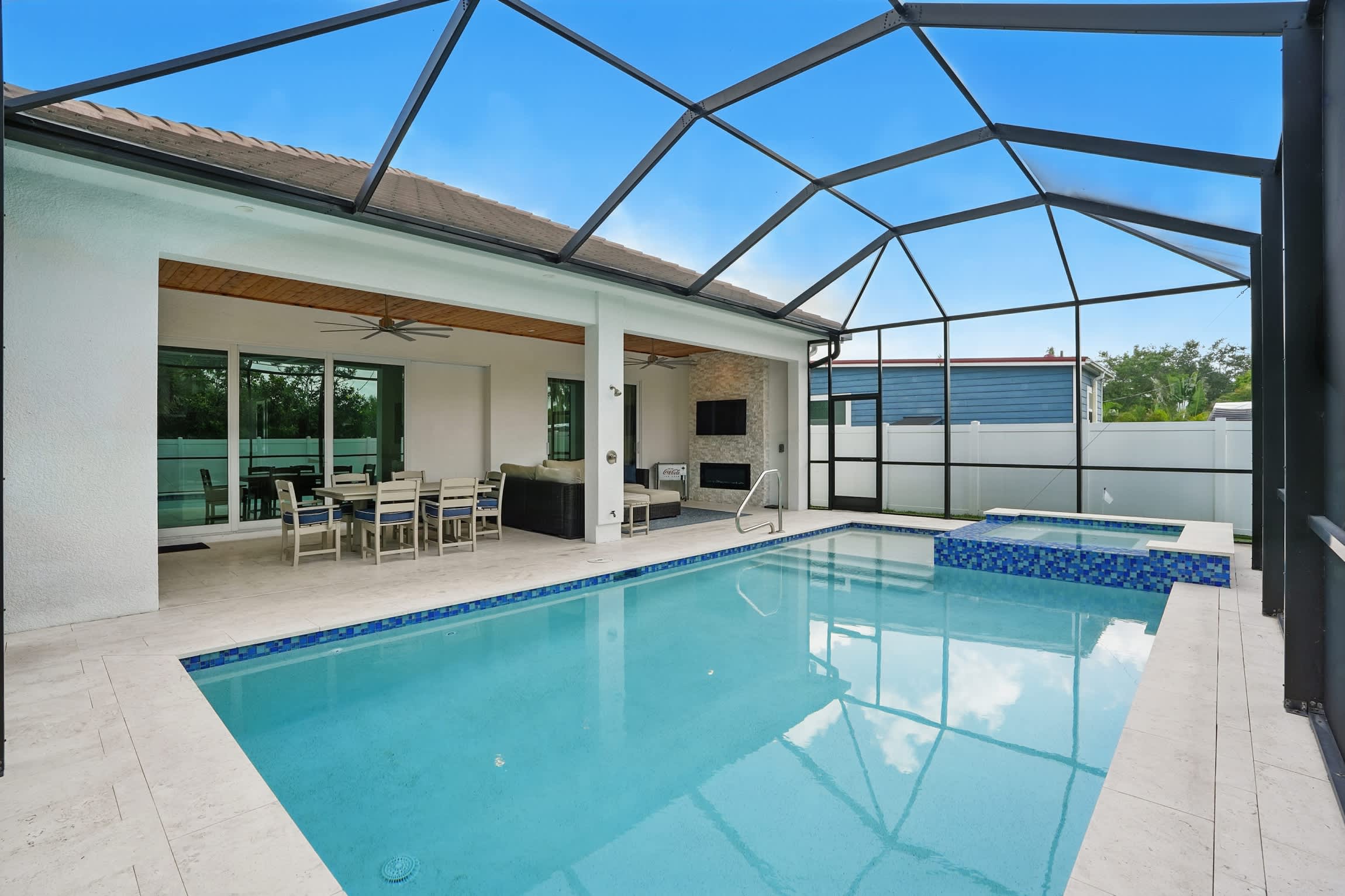 There is a large covered area that has an outdoor TV and built in gas grill 