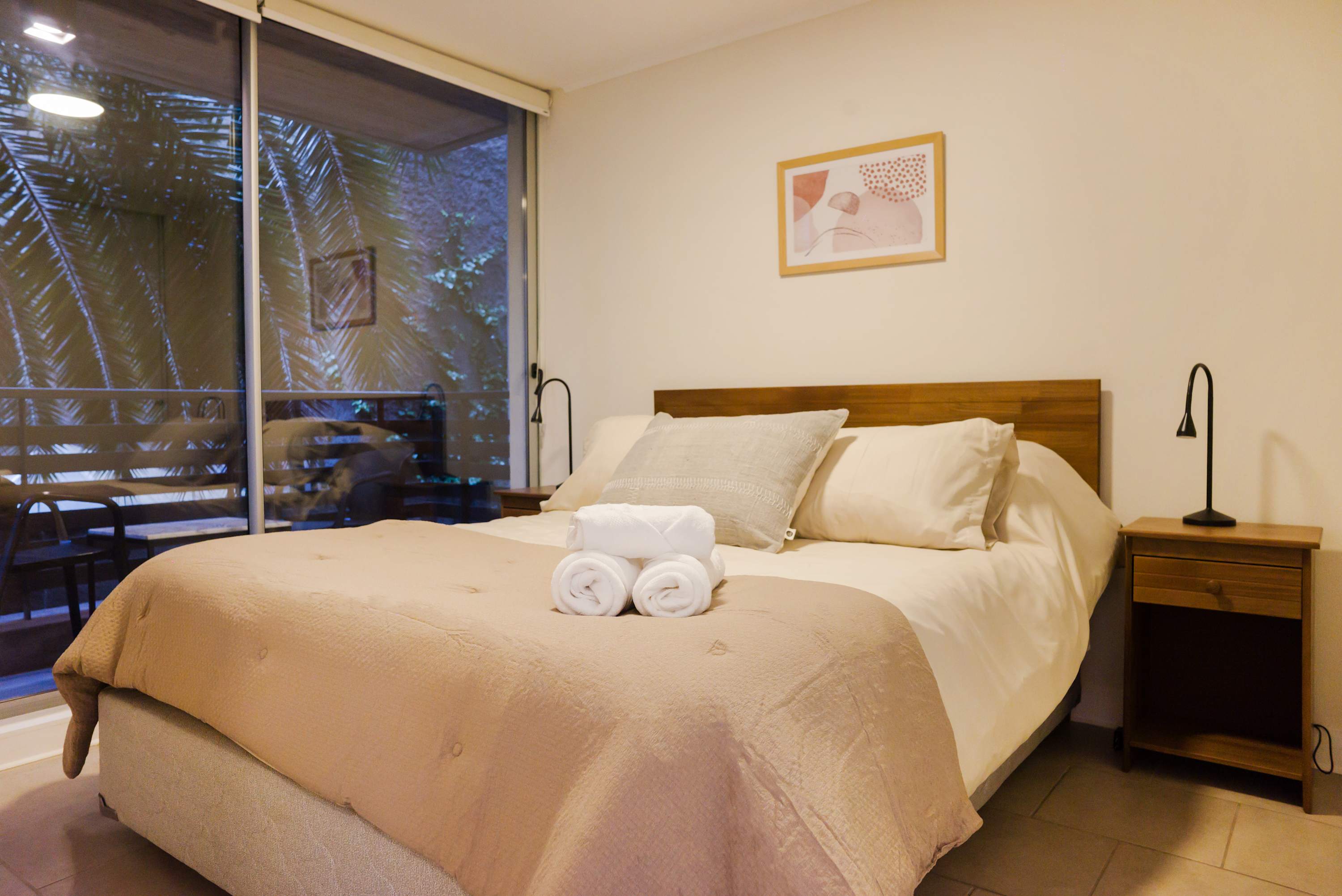 Relax in this cozy bedroom with a private balcony view, perfect for unwinding after a day of exploring.