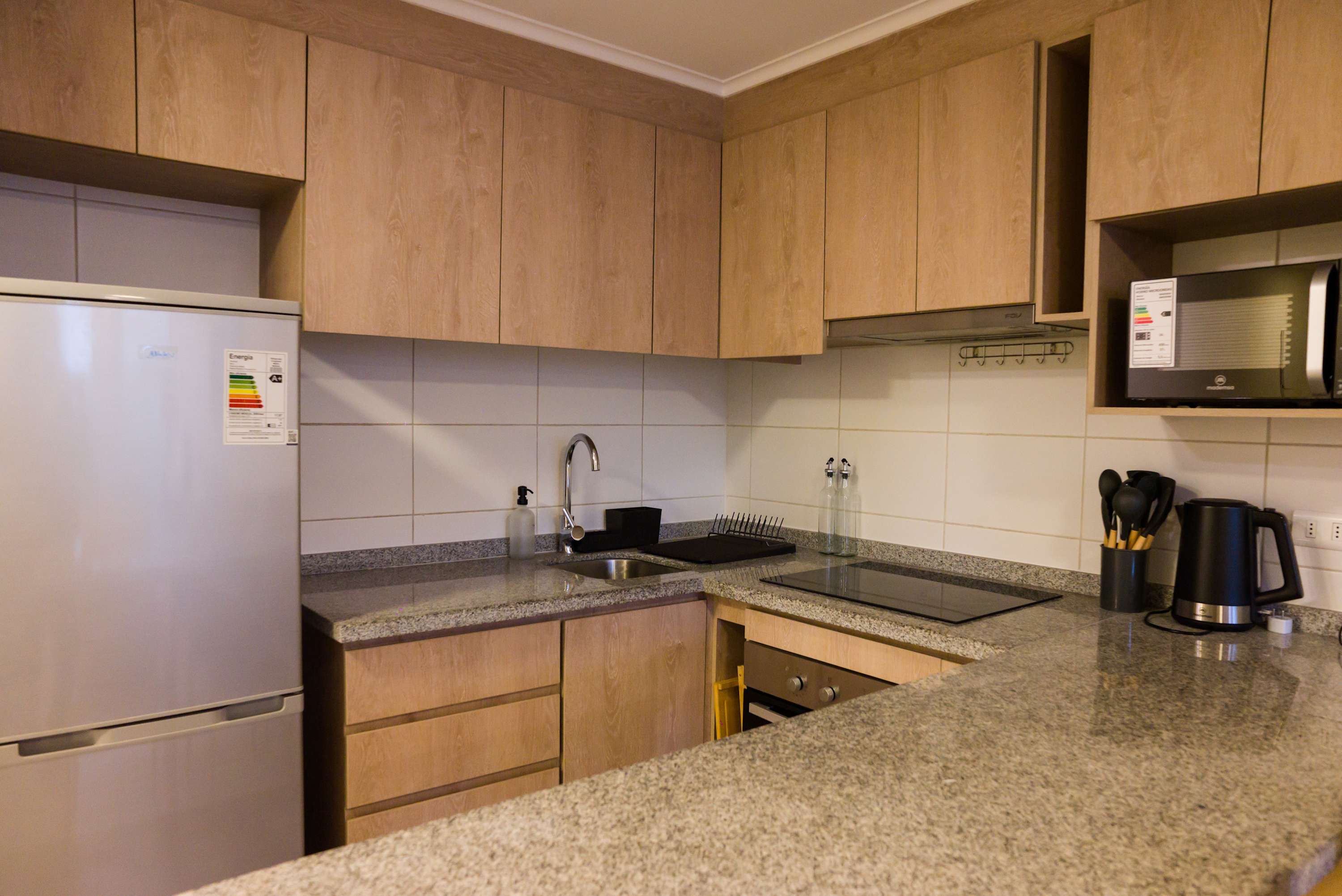 Modern kitchen with sleek appliances and ample storage, perfect for preparing meals during your stay.
