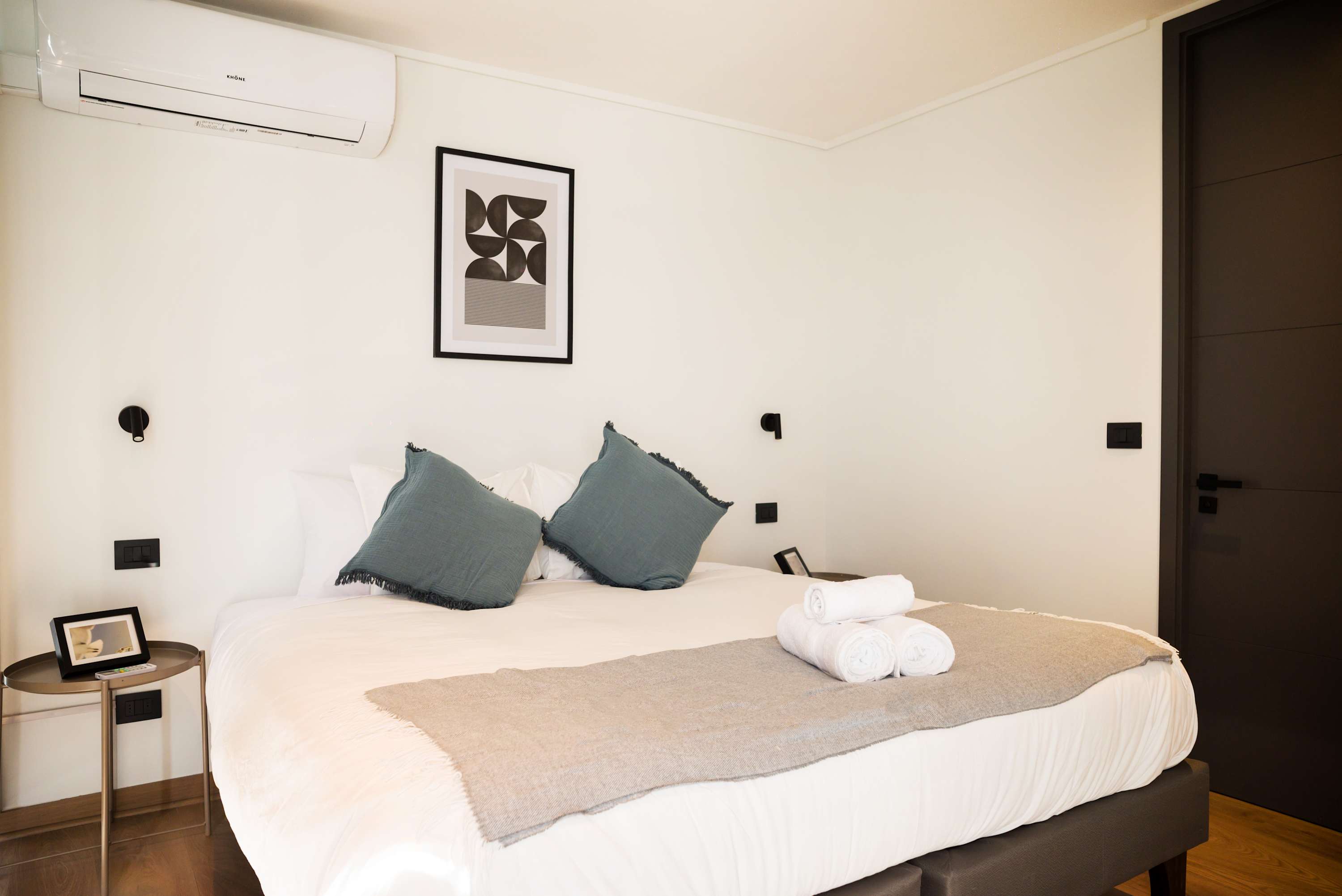 Relax in this serene bedroom with modern decor, plush bedding, and a calming ambiance.