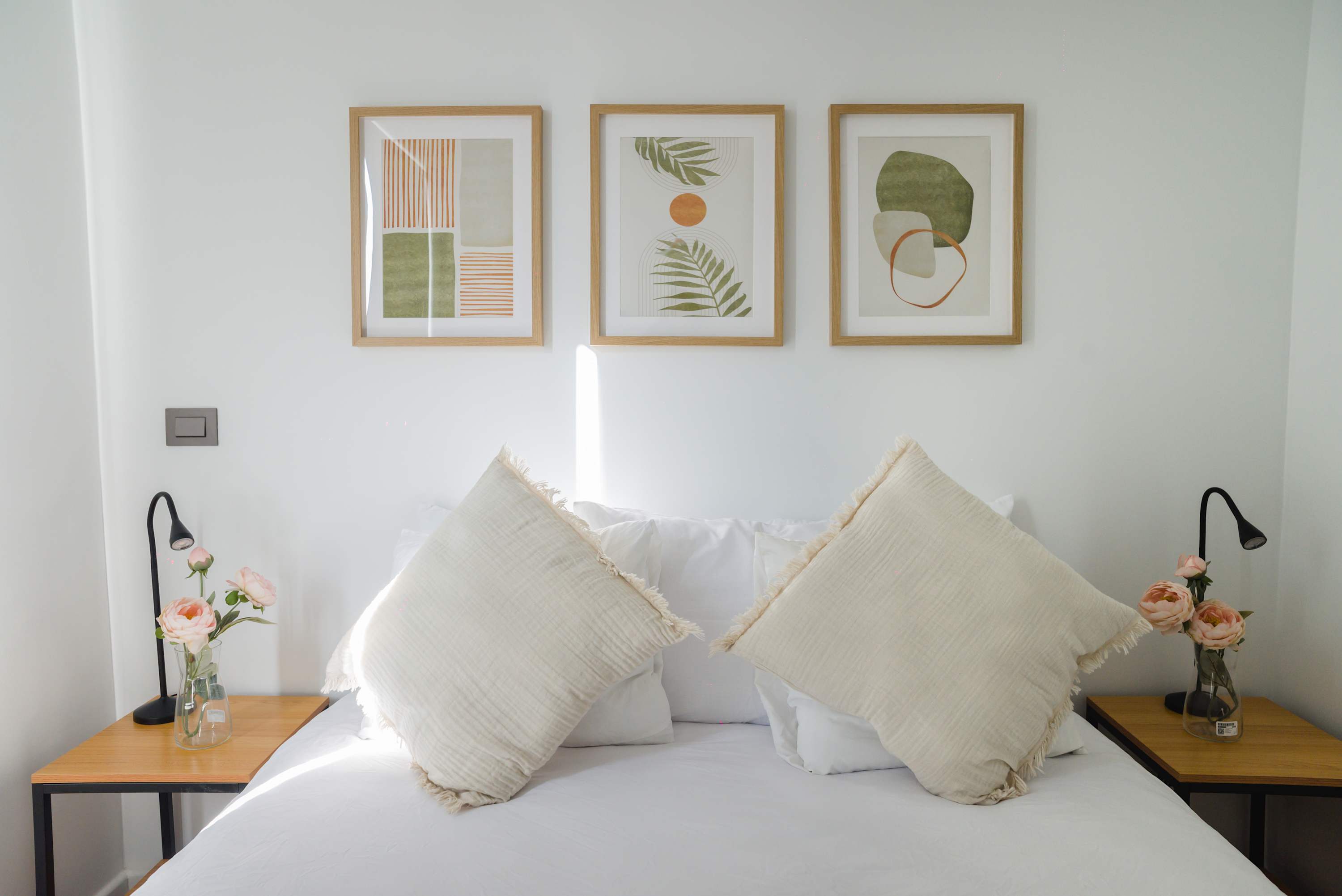 Relax in this serene bedroom with modern decor and cozy touches, perfect for a restful night's sleep.