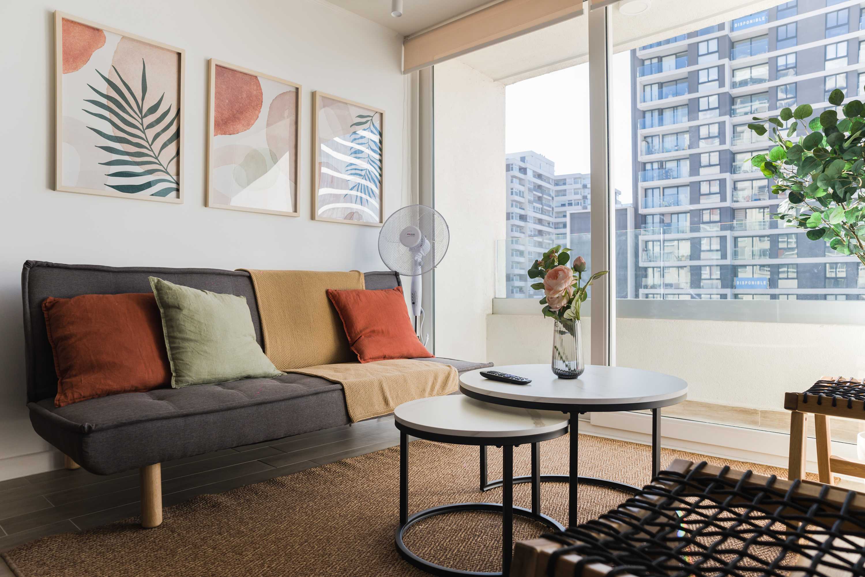 Bright and modern living room with chic decor and stunning city views, perfect for relaxation.