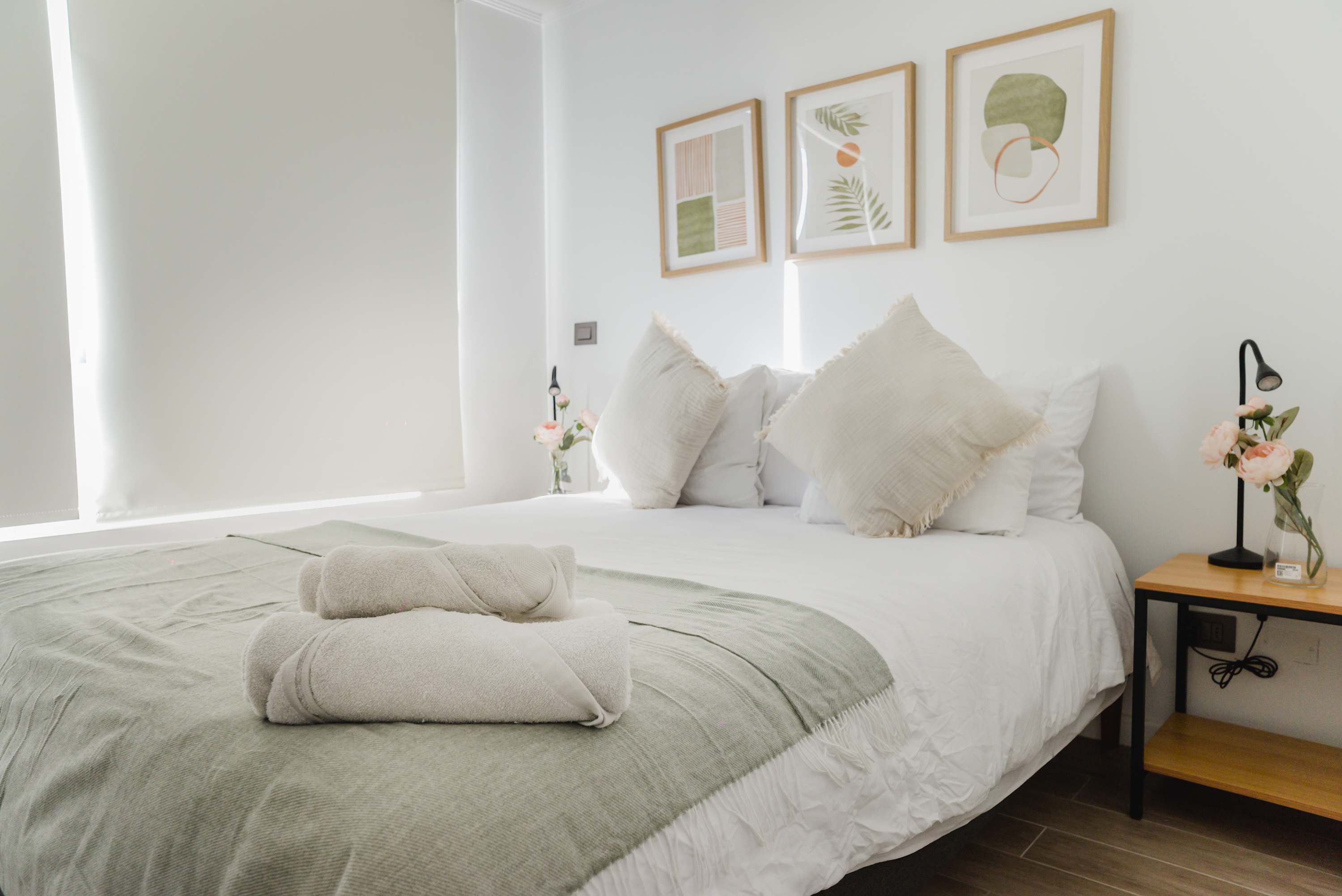 Relax in this serene bedroom with cozy bedding and elegant decor, perfect for a restful stay.