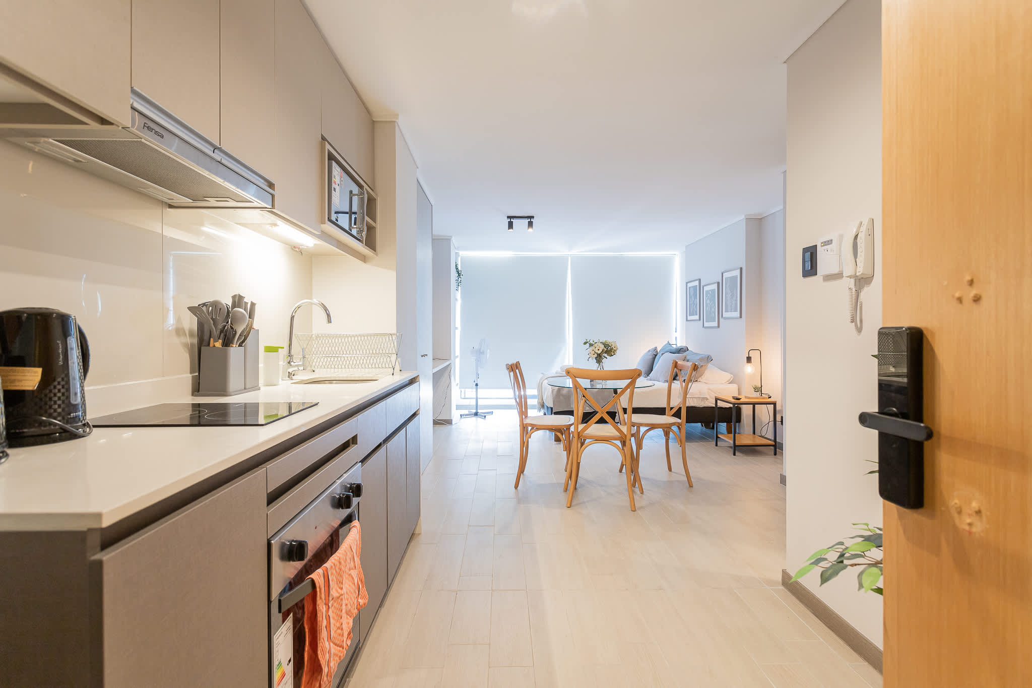 Bright and modern studio with a sleek kitchen and cozy dining area, ideal for a relaxing stay in Chile.