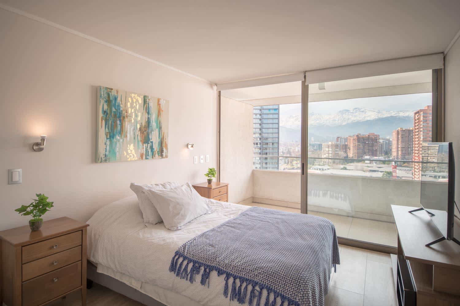 Relax in this bright bedroom with stunning city views and a cozy balcony, perfect for unwinding after a day of exploring.