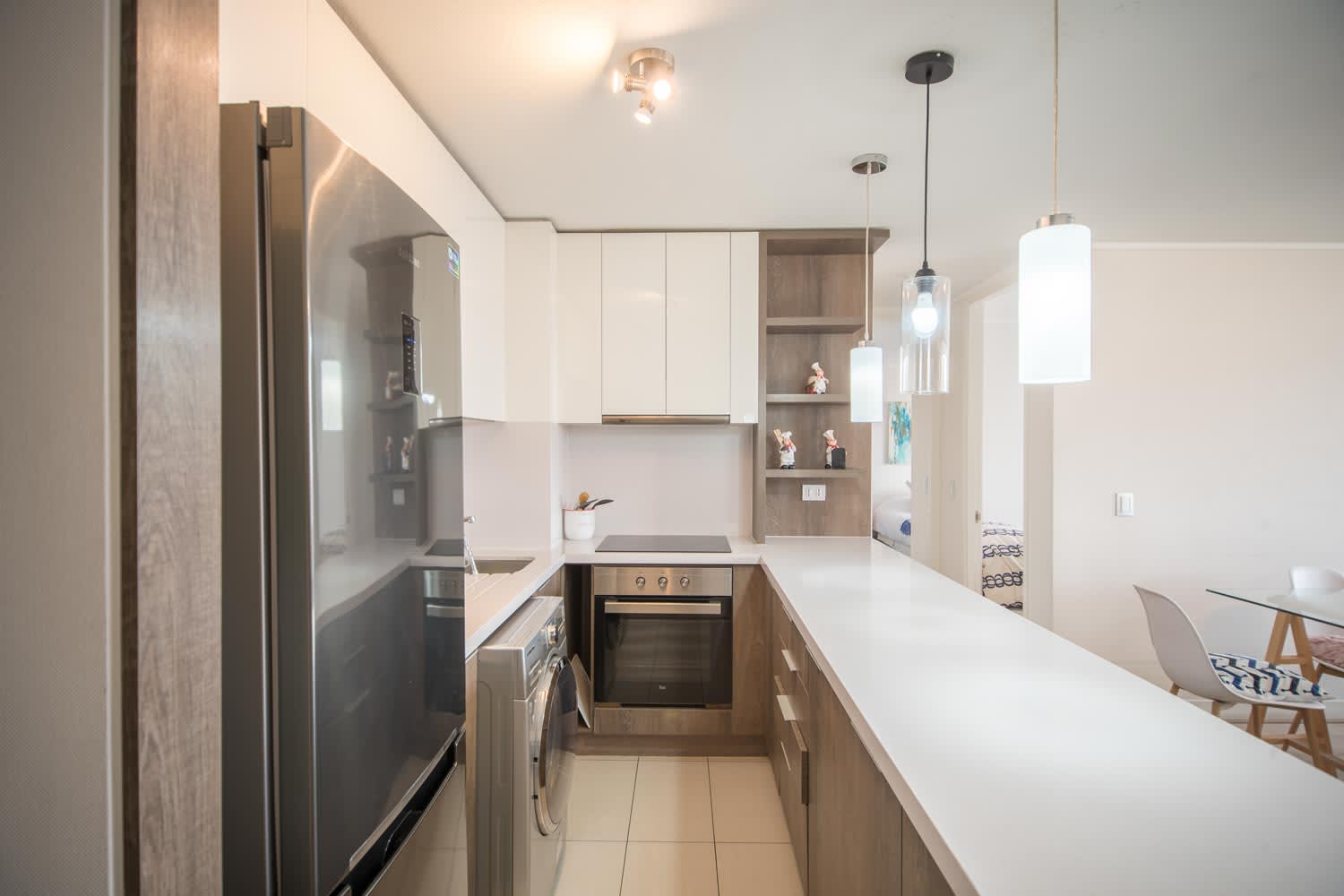 Sleek and modern kitchen with top-notch appliances and stylish lighting, perfect for culinary adventures.