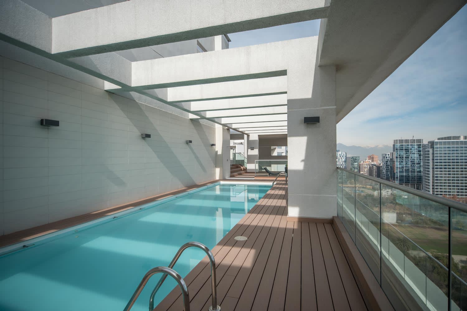 Enjoy a refreshing swim with stunning city views in this modern rooftop pool oasis.