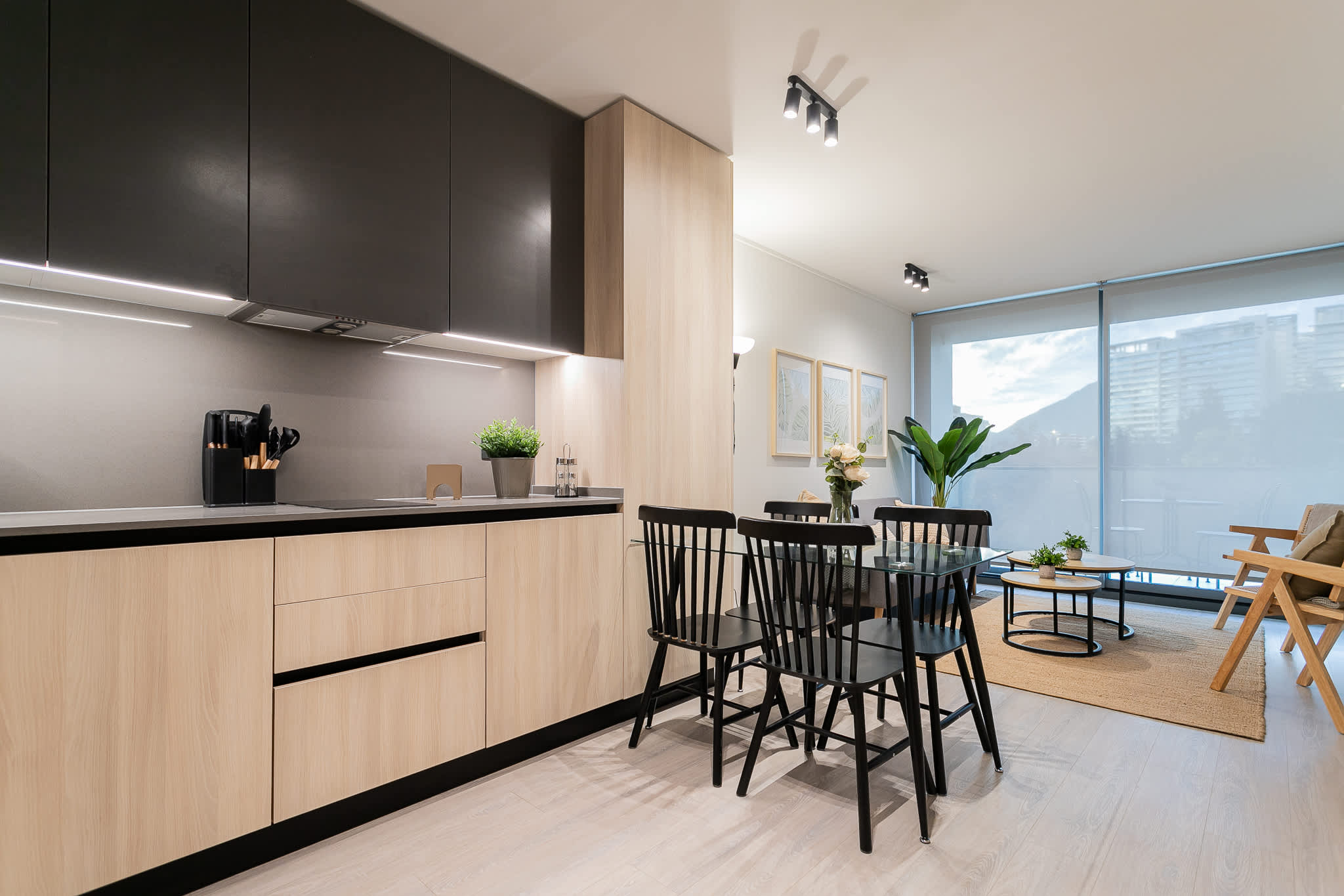 Sleek modern kitchen with ample natural light, perfect for dining and entertaining.