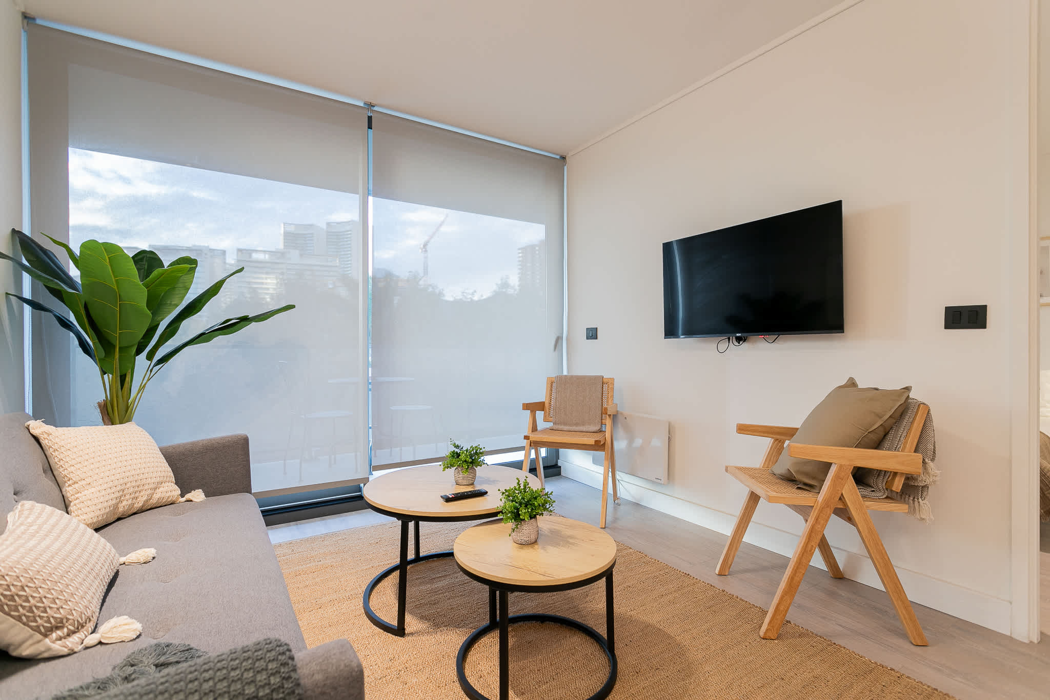Relax in this stylish living room with modern decor, natural light, and a cozy ambiance, perfect for unwinding after a day of exploring.