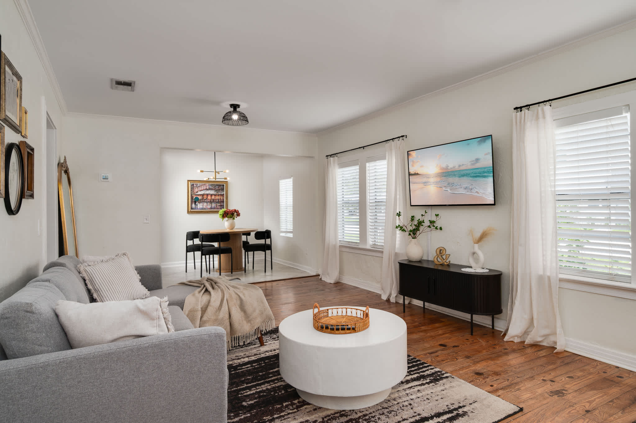 This bright and airy living space offers ample seating and a stylish design, flowing seamlessly into the dining area for easy entertaining