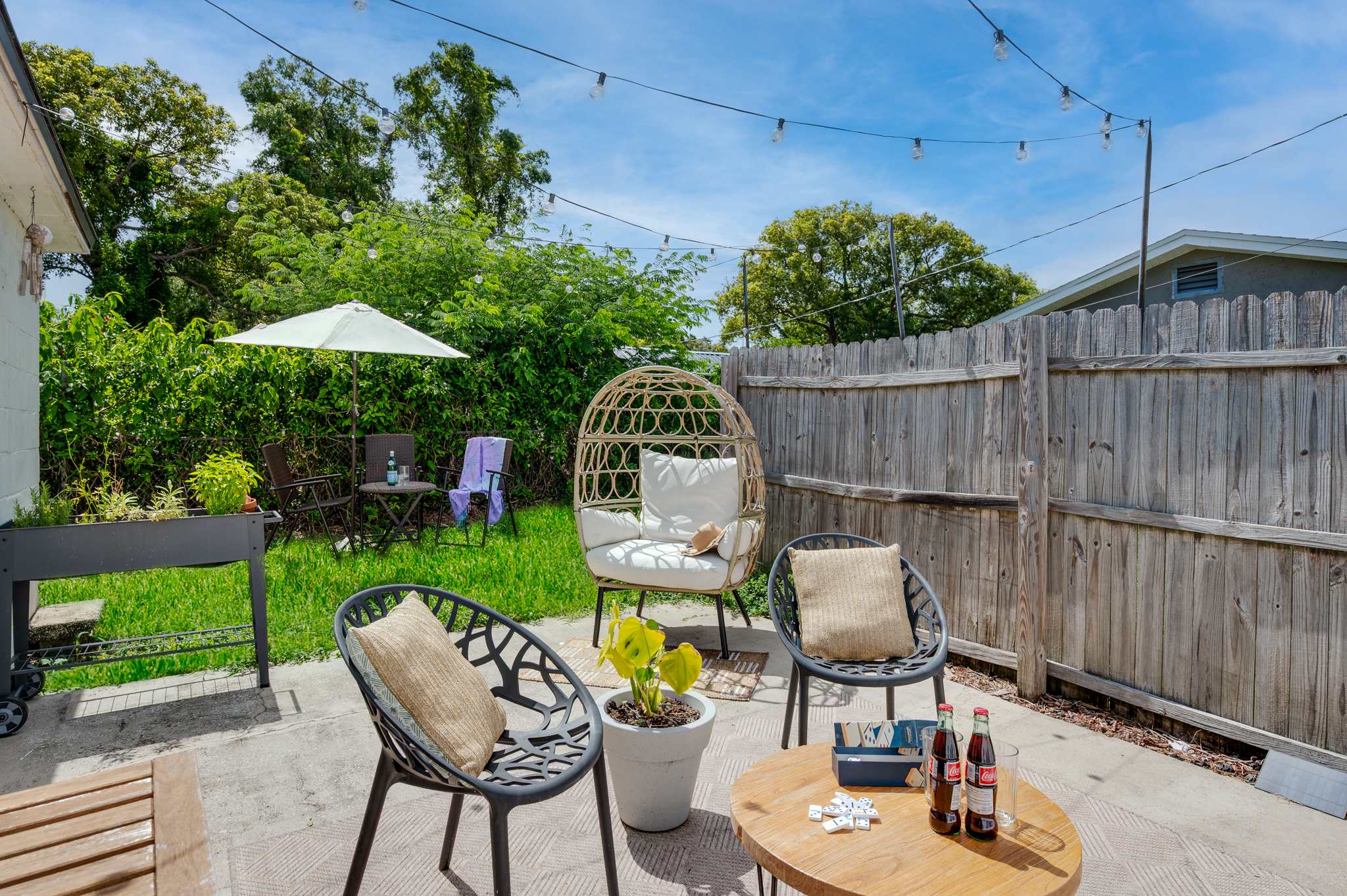 Your bright and inviting private patio awaits! Enjoy the Florida sunshine in this charming outdoor space, complete with comfortable seating and ambient string lights.