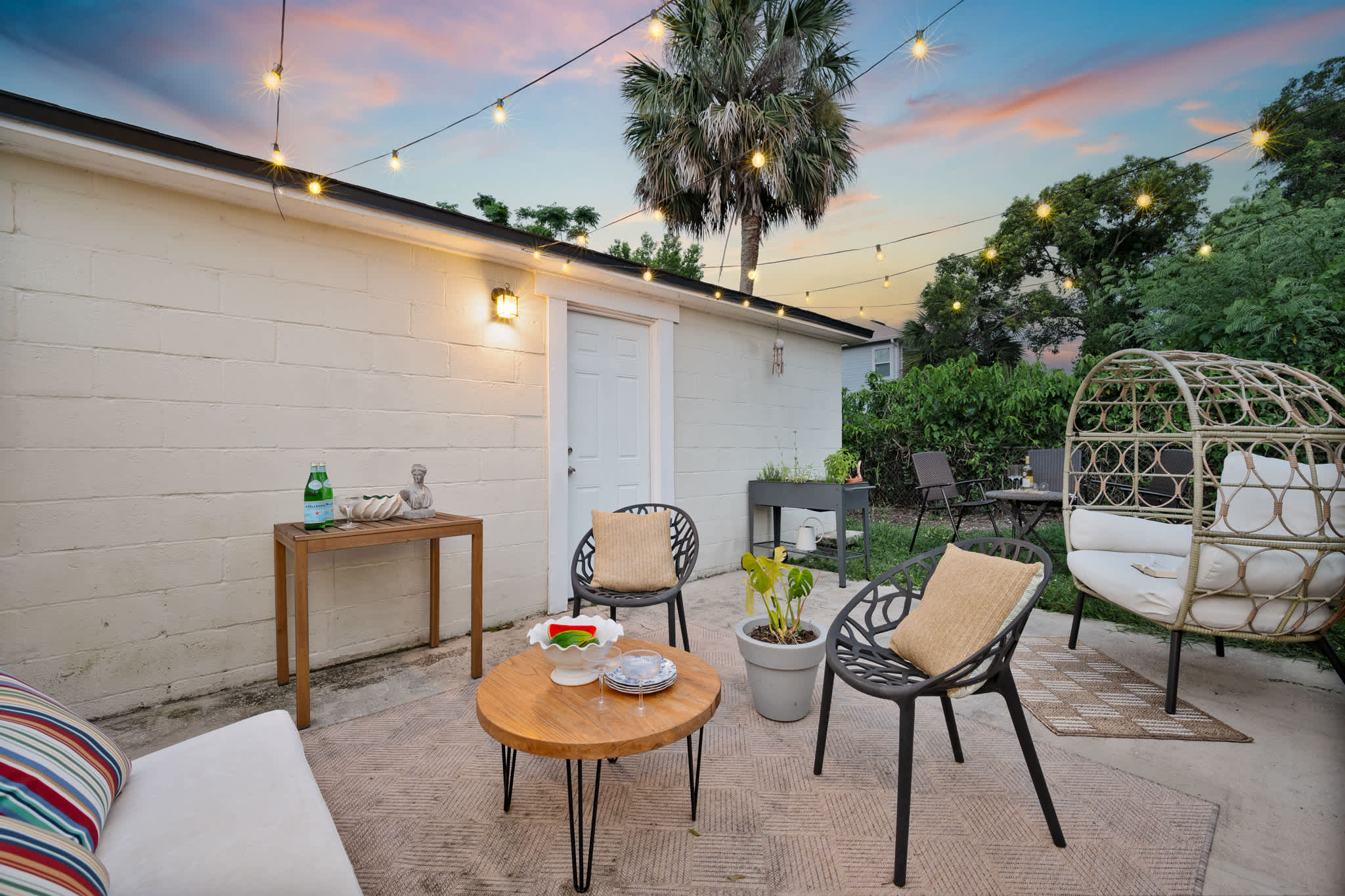 Create lasting memories in our enchanting backyard patio, strung with lights for perfect evening gatherings.