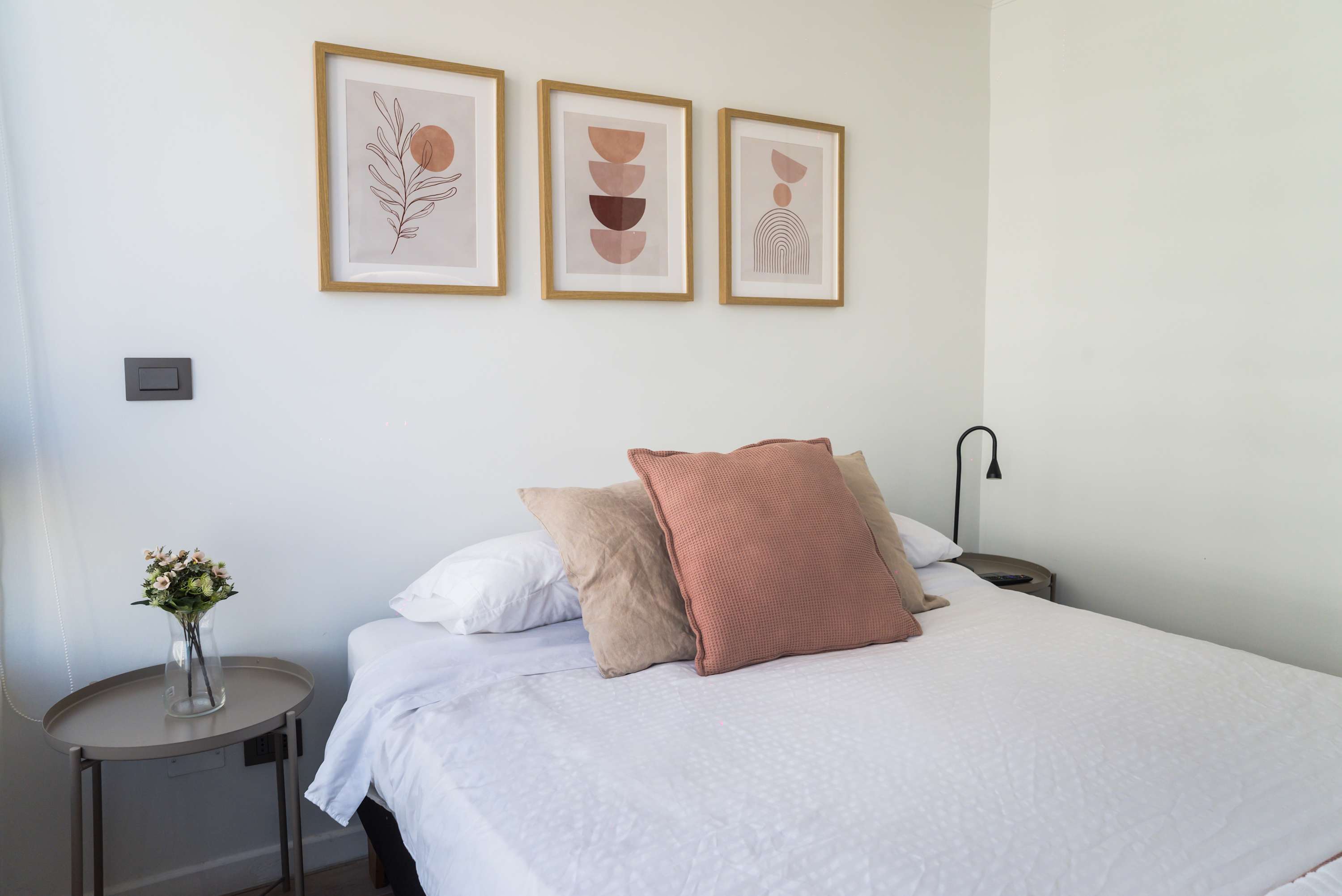 Unwind in this serene bedroom with stylish decor and cozy bedding, perfect for a restful night's sleep.