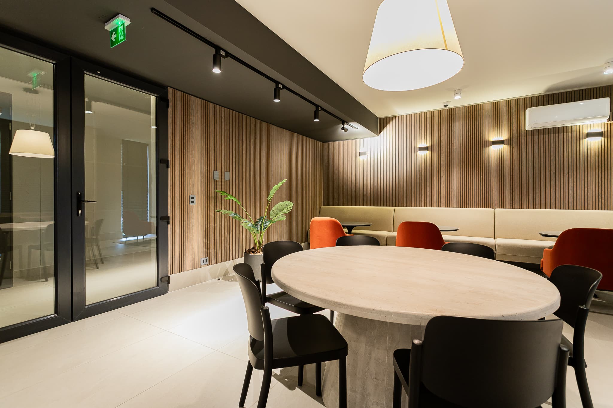 Relax in this stylish lounge with modern seating and warm lighting, perfect for unwinding or socializing.